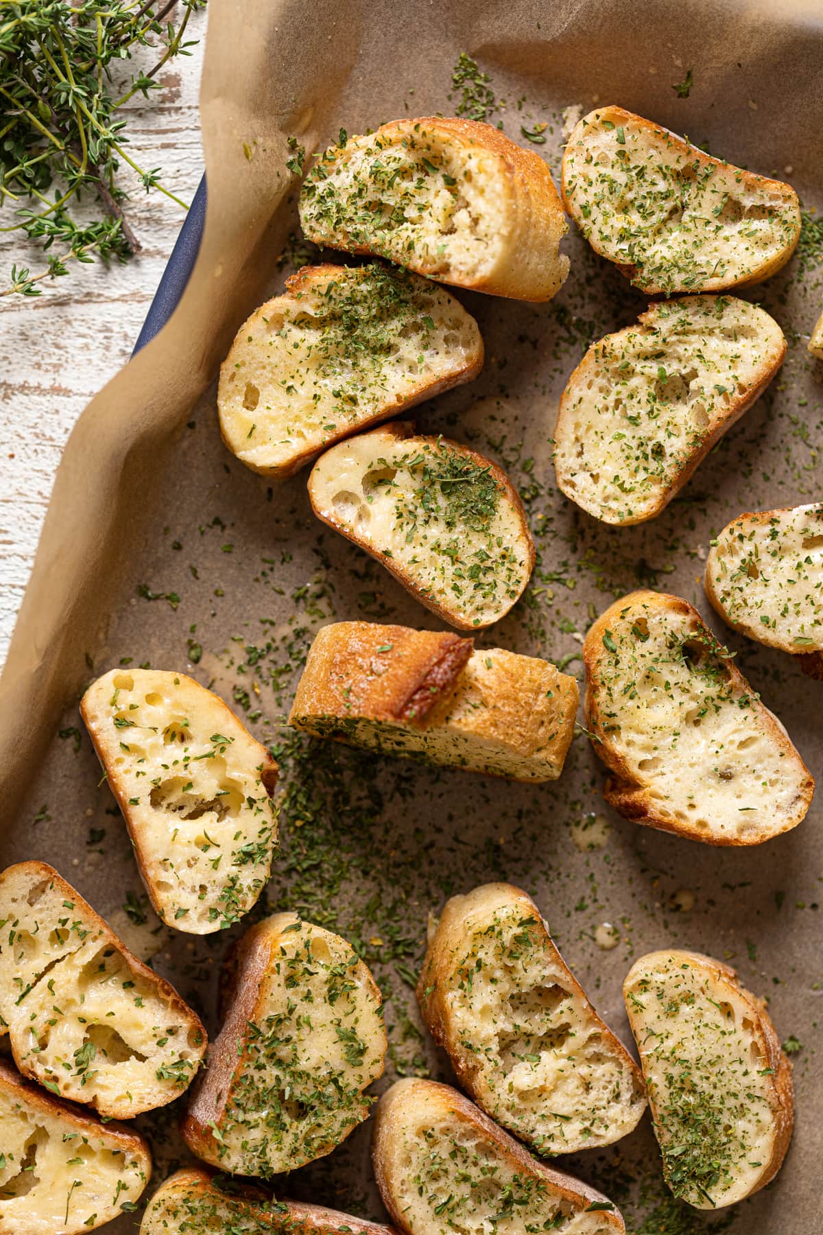 Seasoned bread slices on a baking sheet