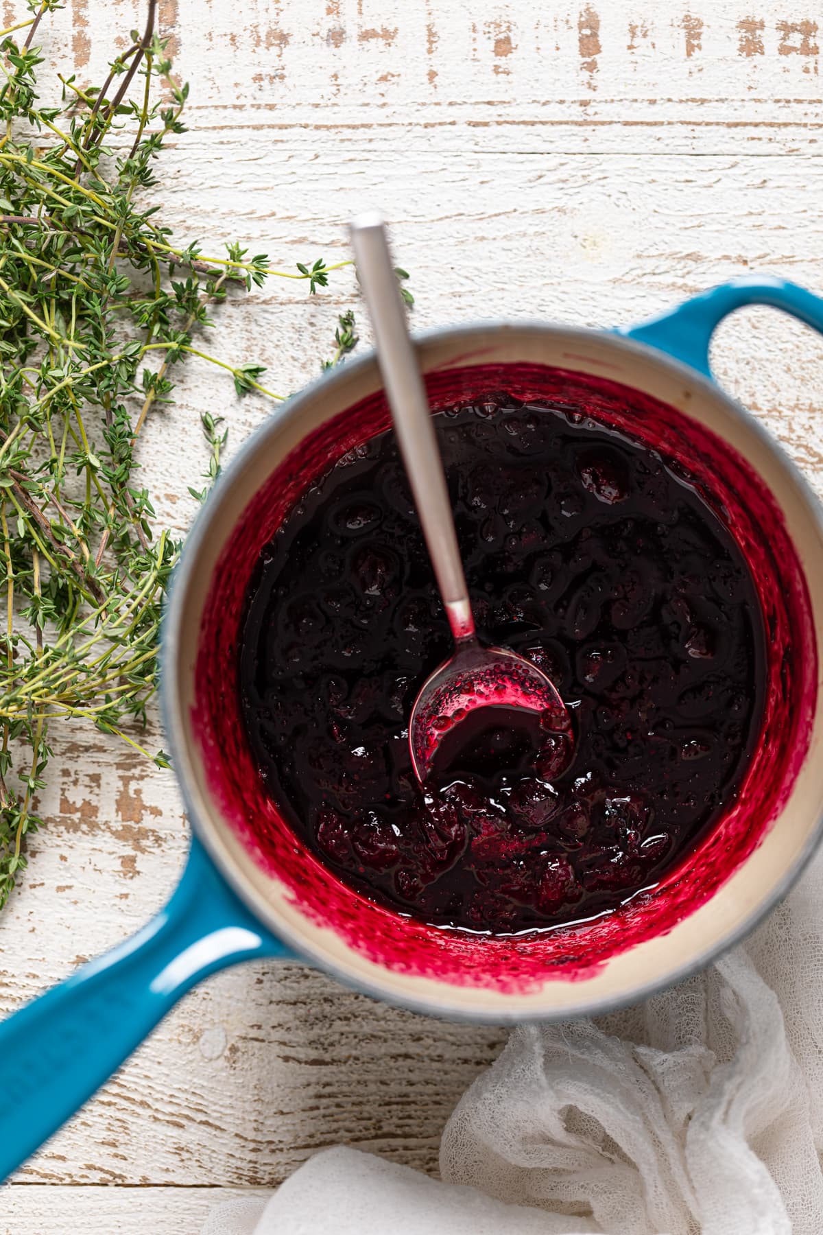 Spoon in a pan of blueberry compote