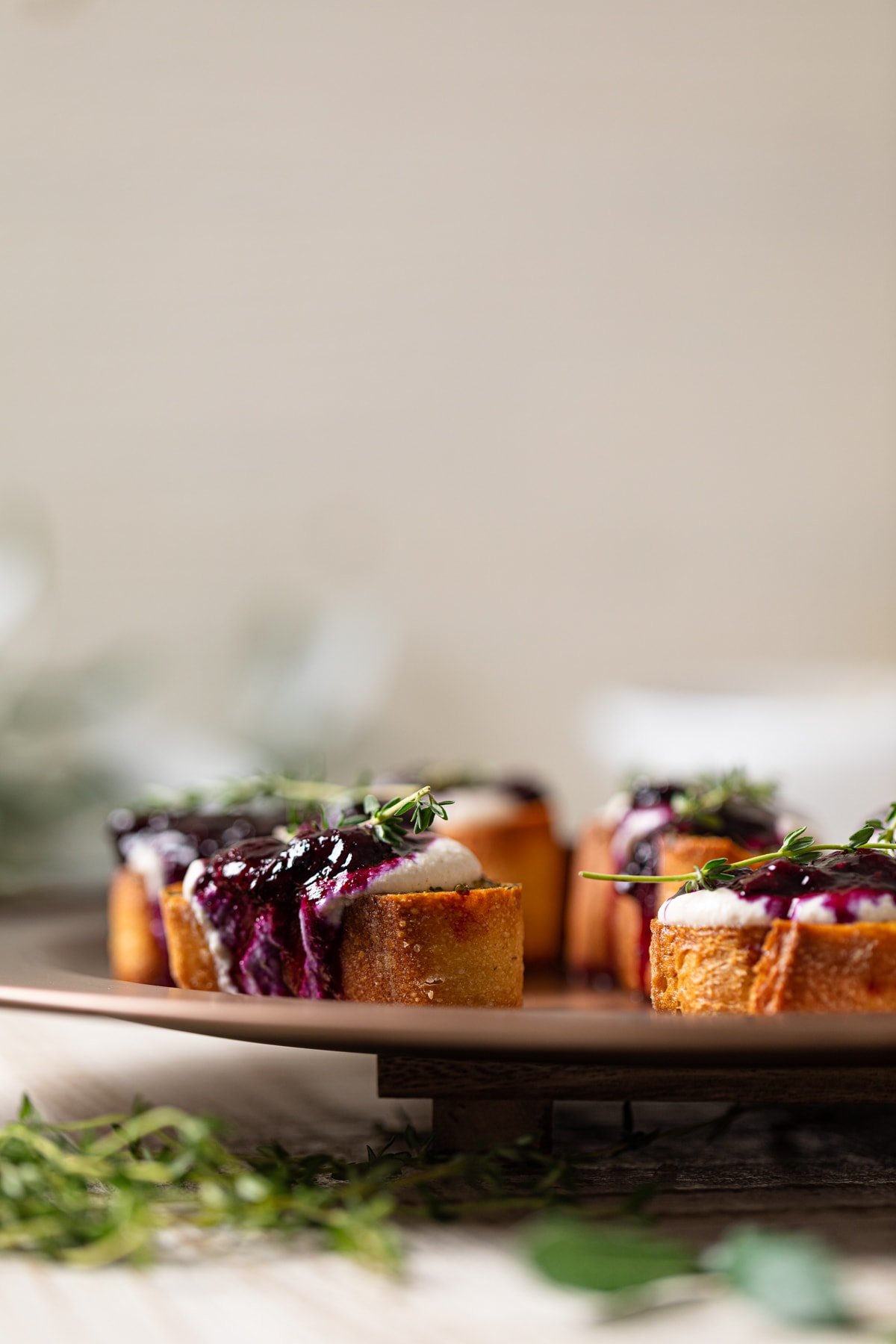 Vegan Blueberry Crostinis on an elevated serving dish