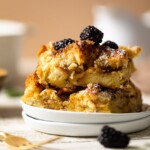 Pieces of Cinnamon Brown Butter French Toast Casserole on two small, stacked plates