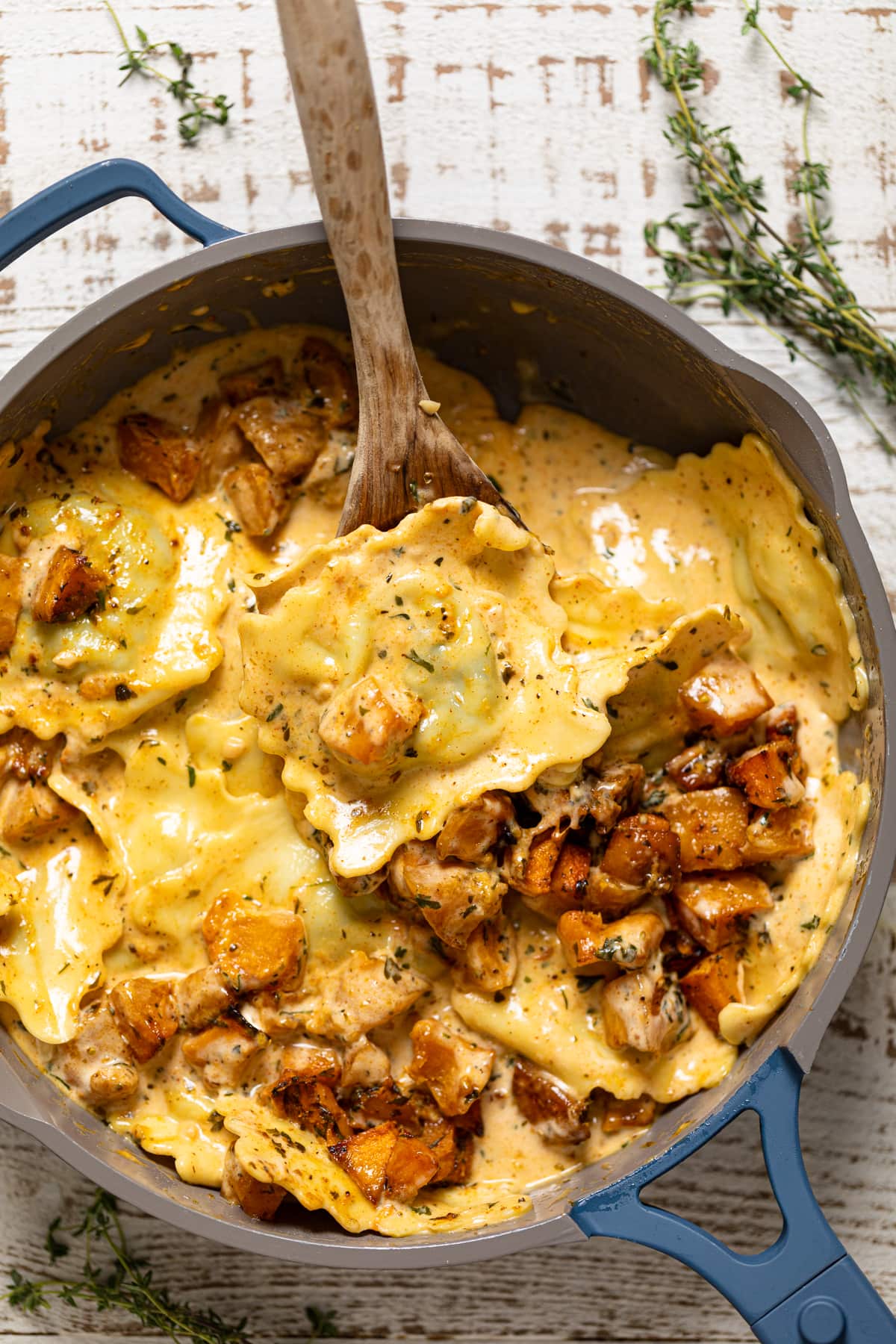 Wooden spoon scopping Roasted Butternut Squash Pasta with Parmesan Garlic Sauce