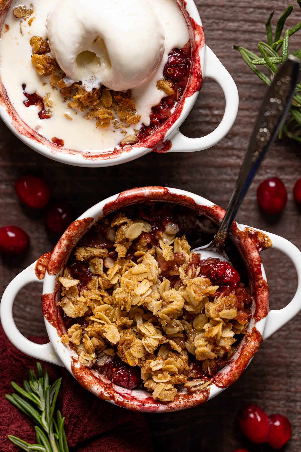 Small handled bowls of Vegan Apple Cranberry Crisp