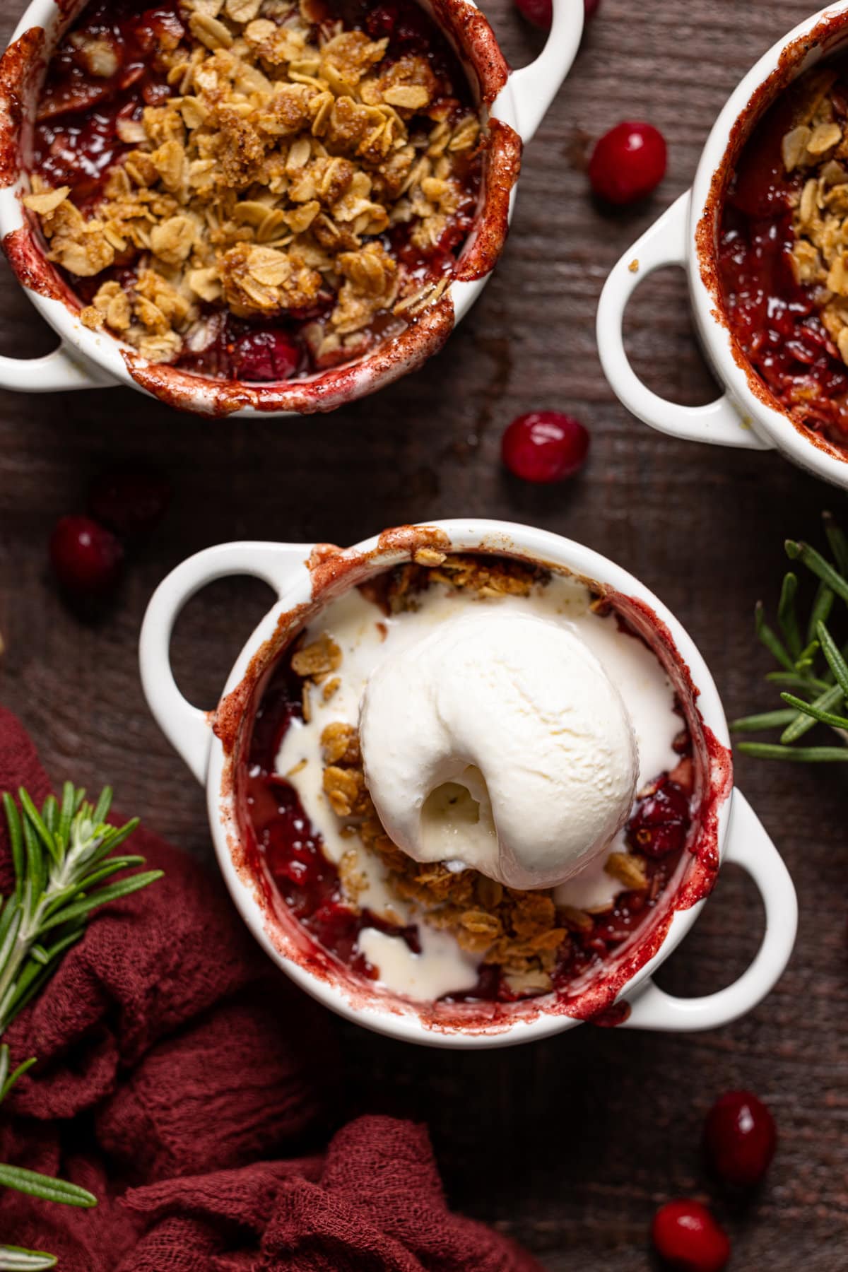 Closeup of a Vegan Apple Cranberry Crisp topped with ice cream