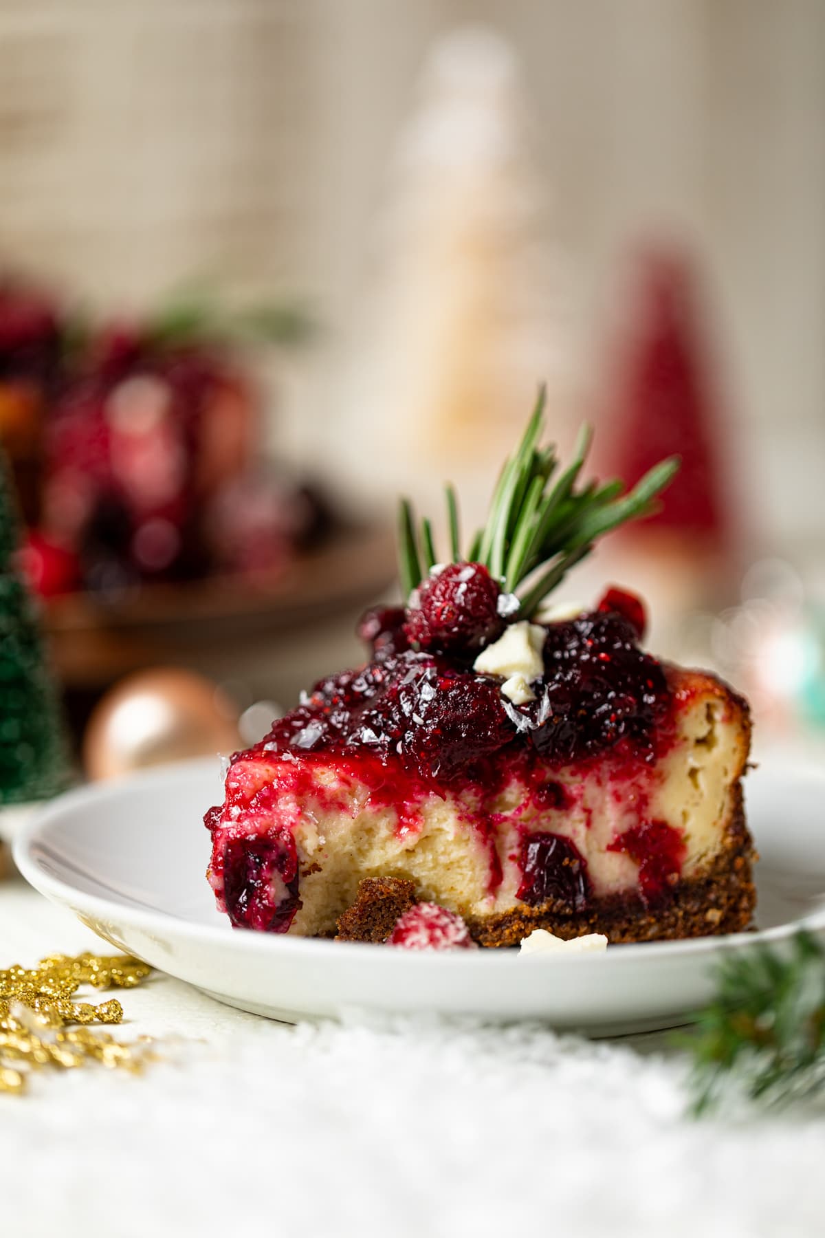 Slice of White Chocolate Cheesecake with Cranberries on a small plate