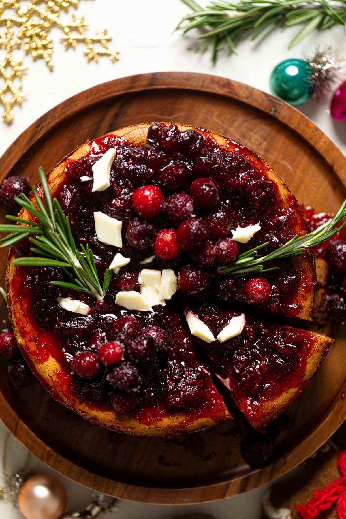 White Chocolate Cheesecake with Cranberries with one slice pulled out