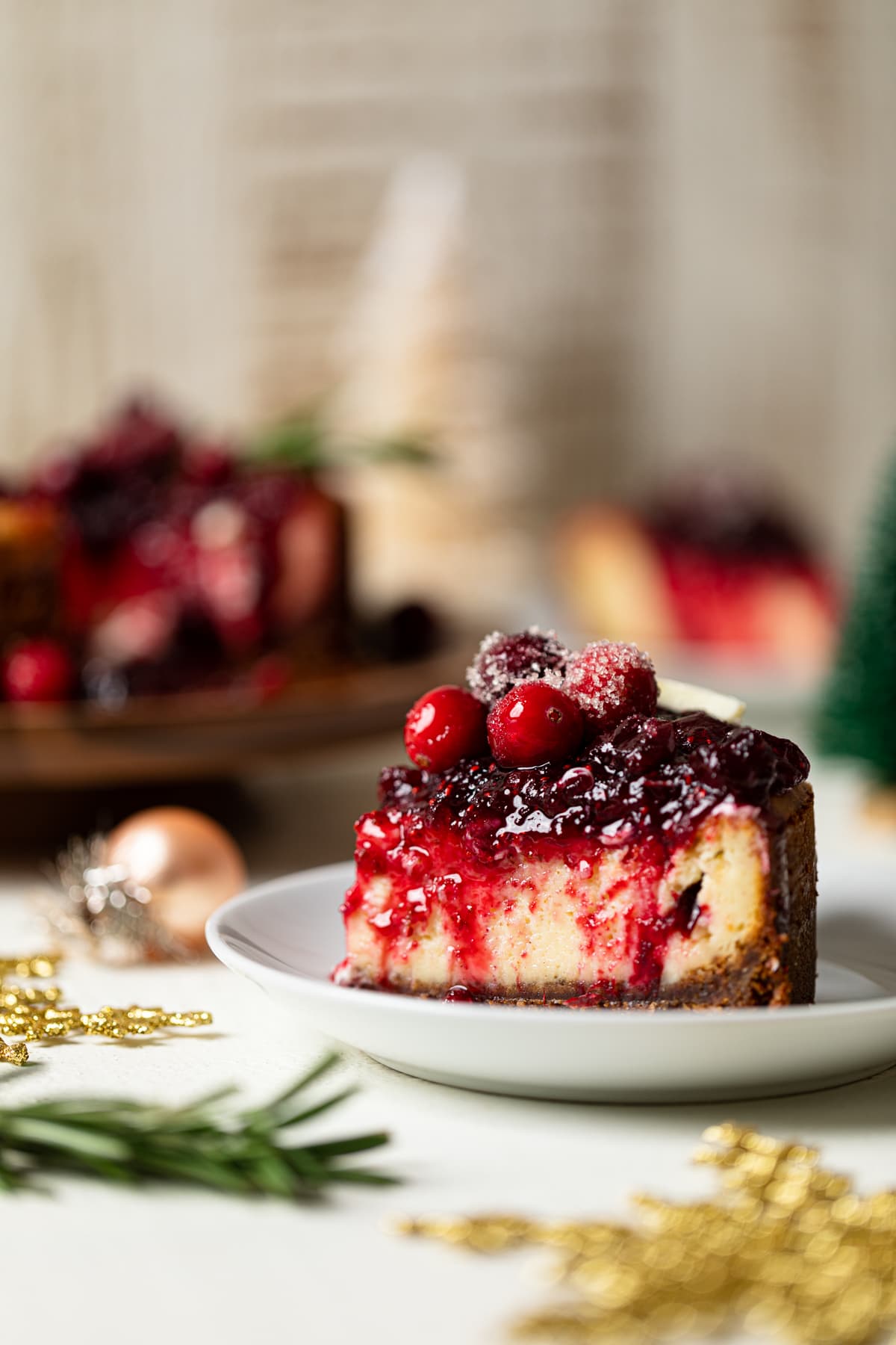 Slice of White Chocolate Cheesecake with Cranberries on a small plate