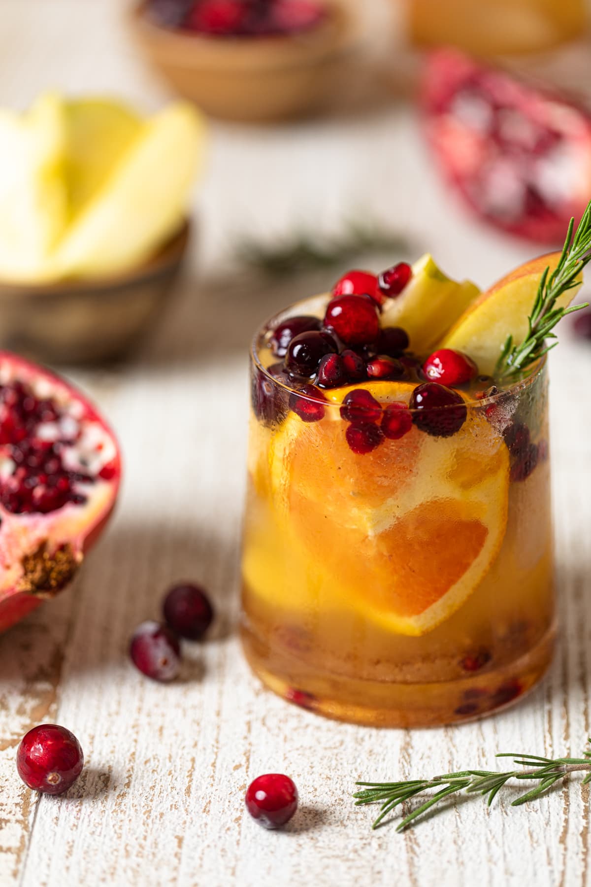 Thanksgiving Punch Mocktail next to a halved pomegranate