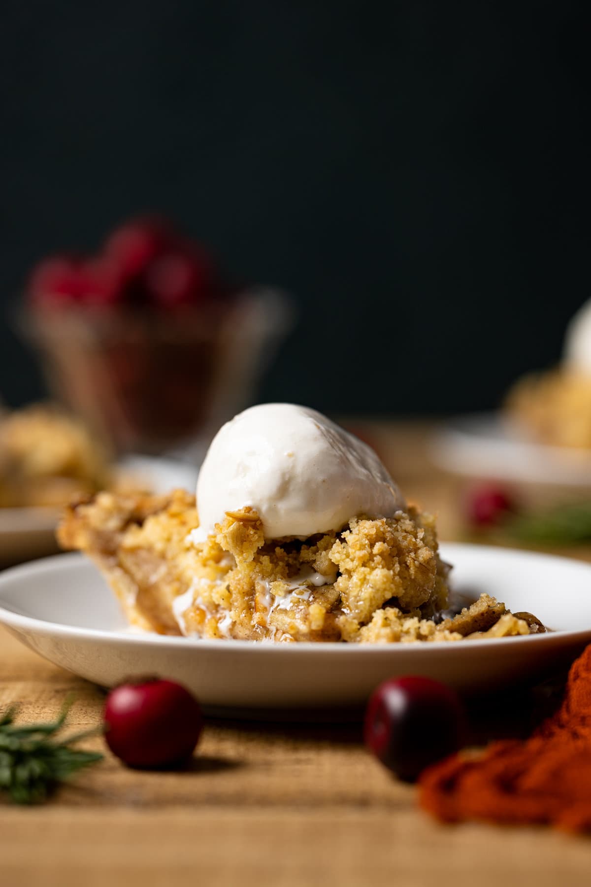 Closeup of a slice of Dutch Apple Pie topped with ice cream