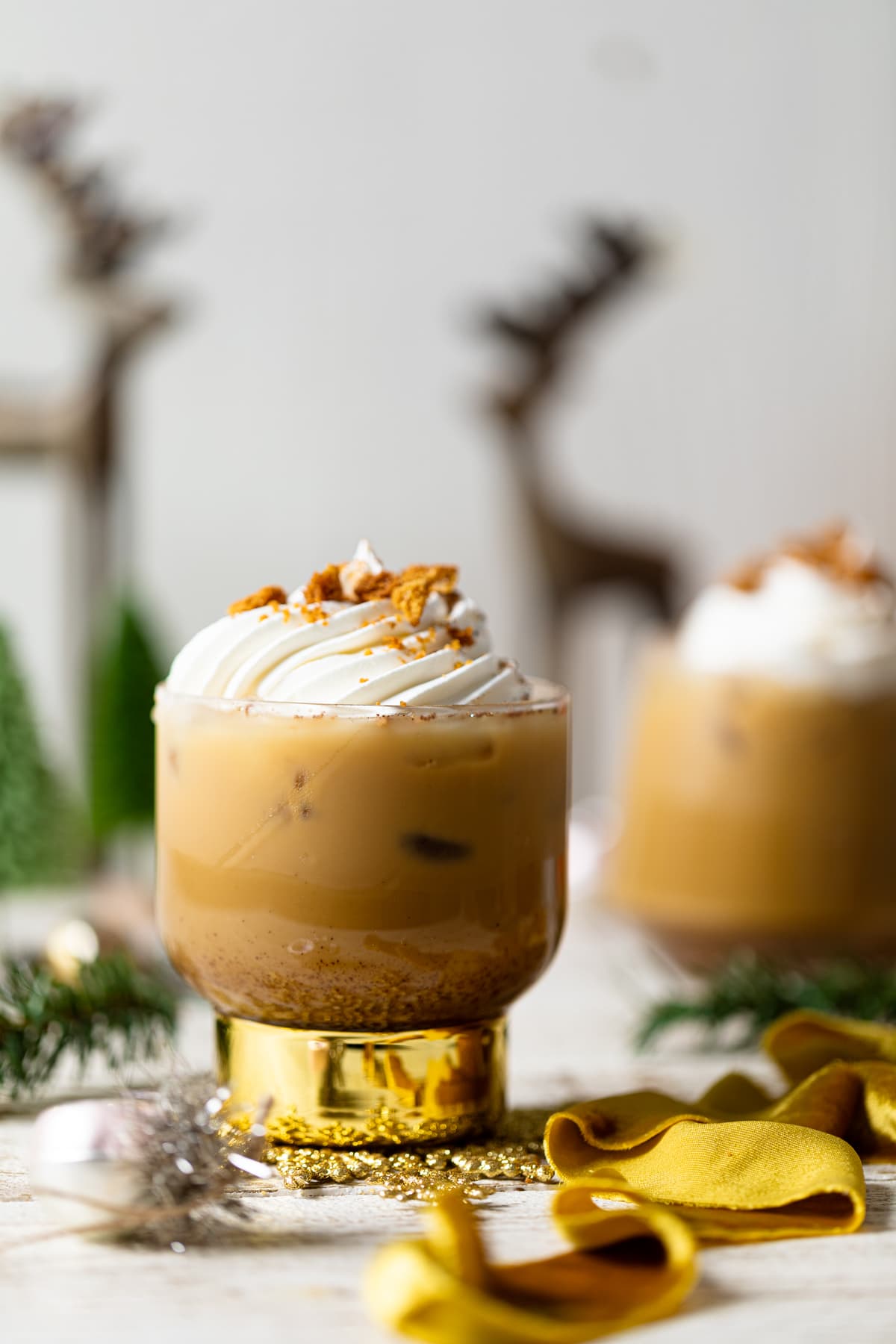 Gingerbread Eggnog Mocktail in a gold-stemmed glass