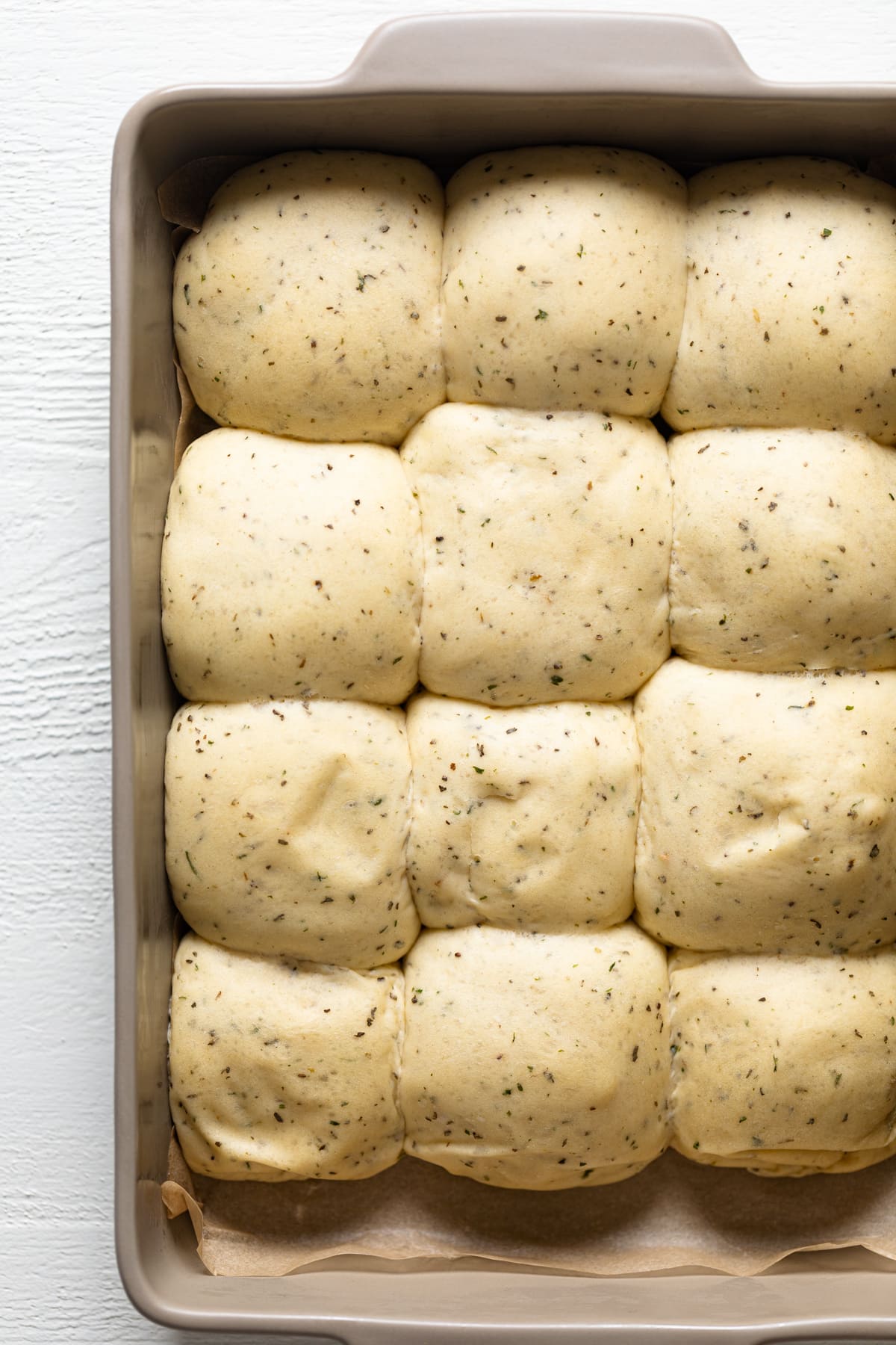 Raw Hot Honey Herb Dinner Rolls in a baking dish