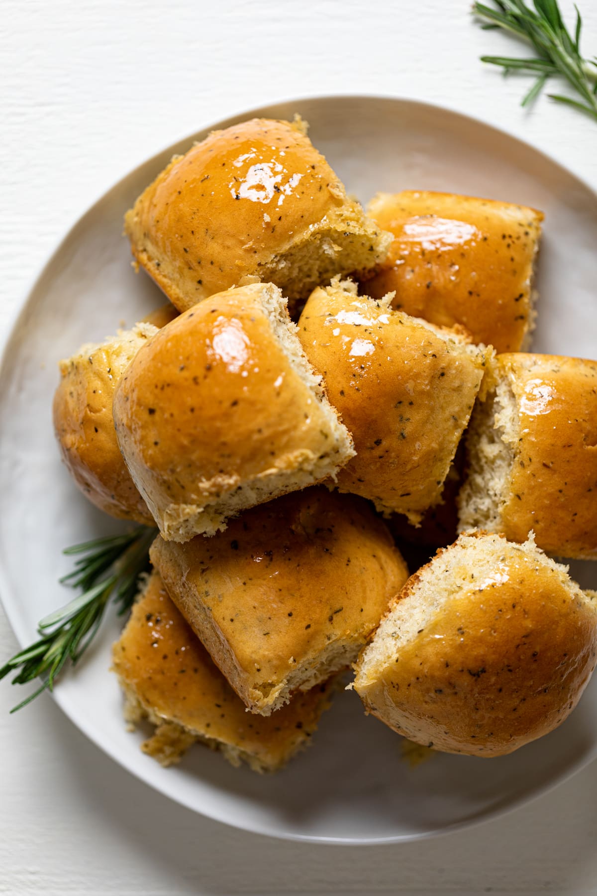 Pile of Hot Honey Herb Dinner Rolls on a plate