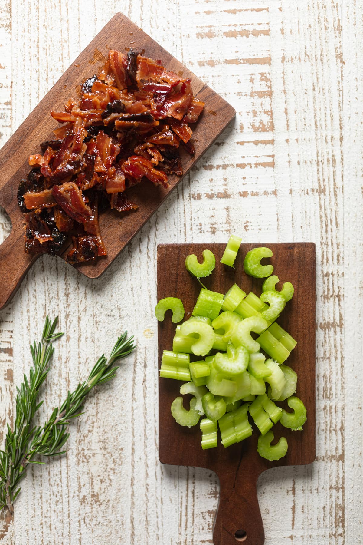 Chopped bacon and celery on wooden boards