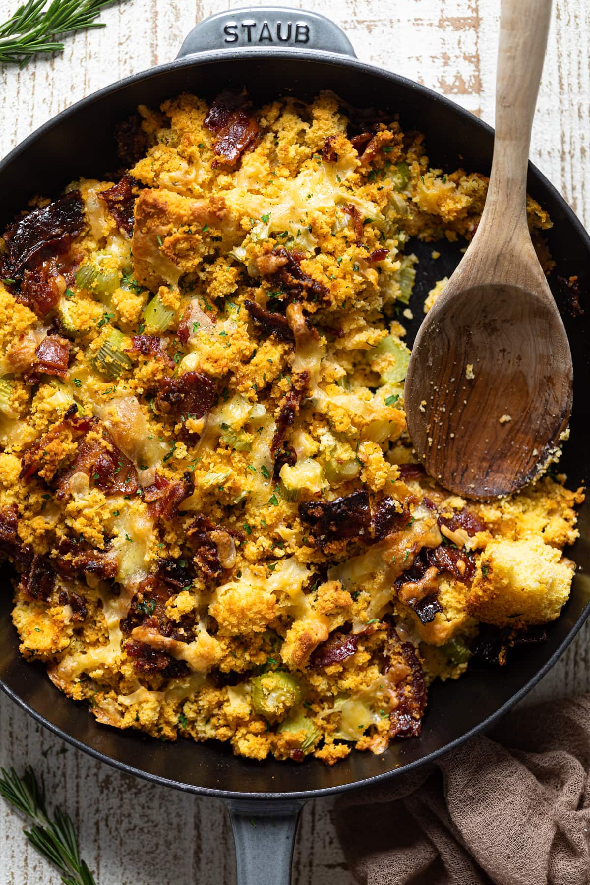 Wooden spoon in a skillet of Southern-Styled Cornbread Stuffing