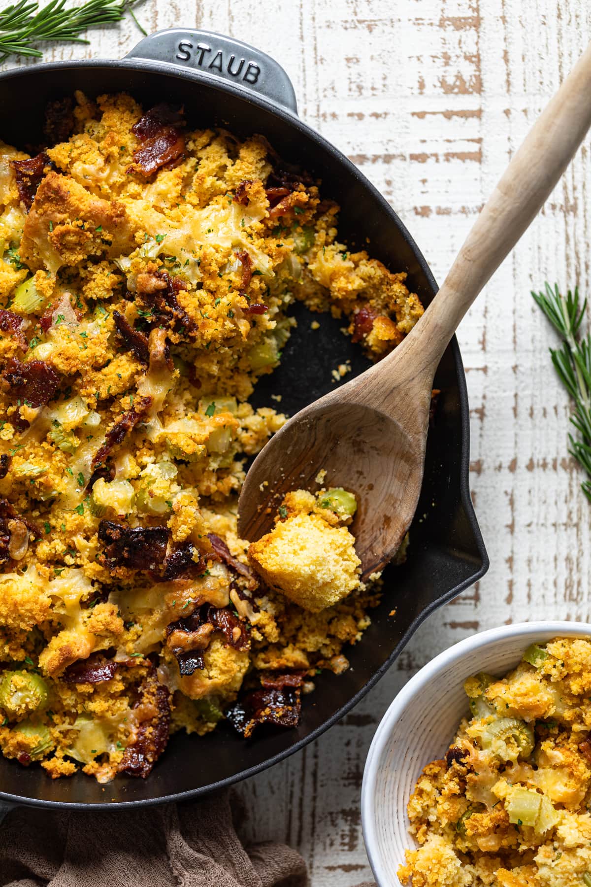 Wooden spoon scooping Southern-Styled Cornbread Stuffing into a bowl