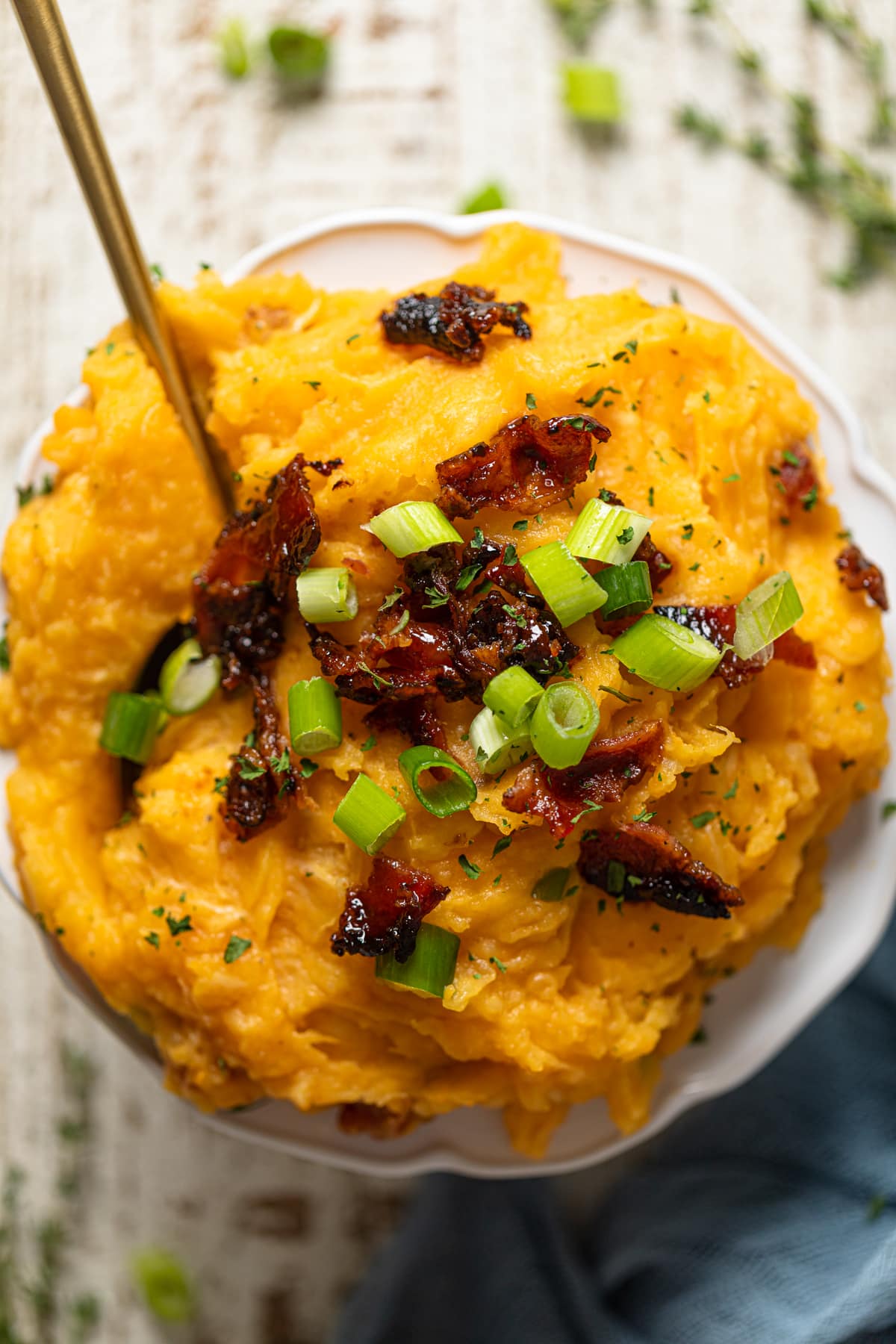 Closeup of Loaded Mashed Potatoes topped with bacon and green onion