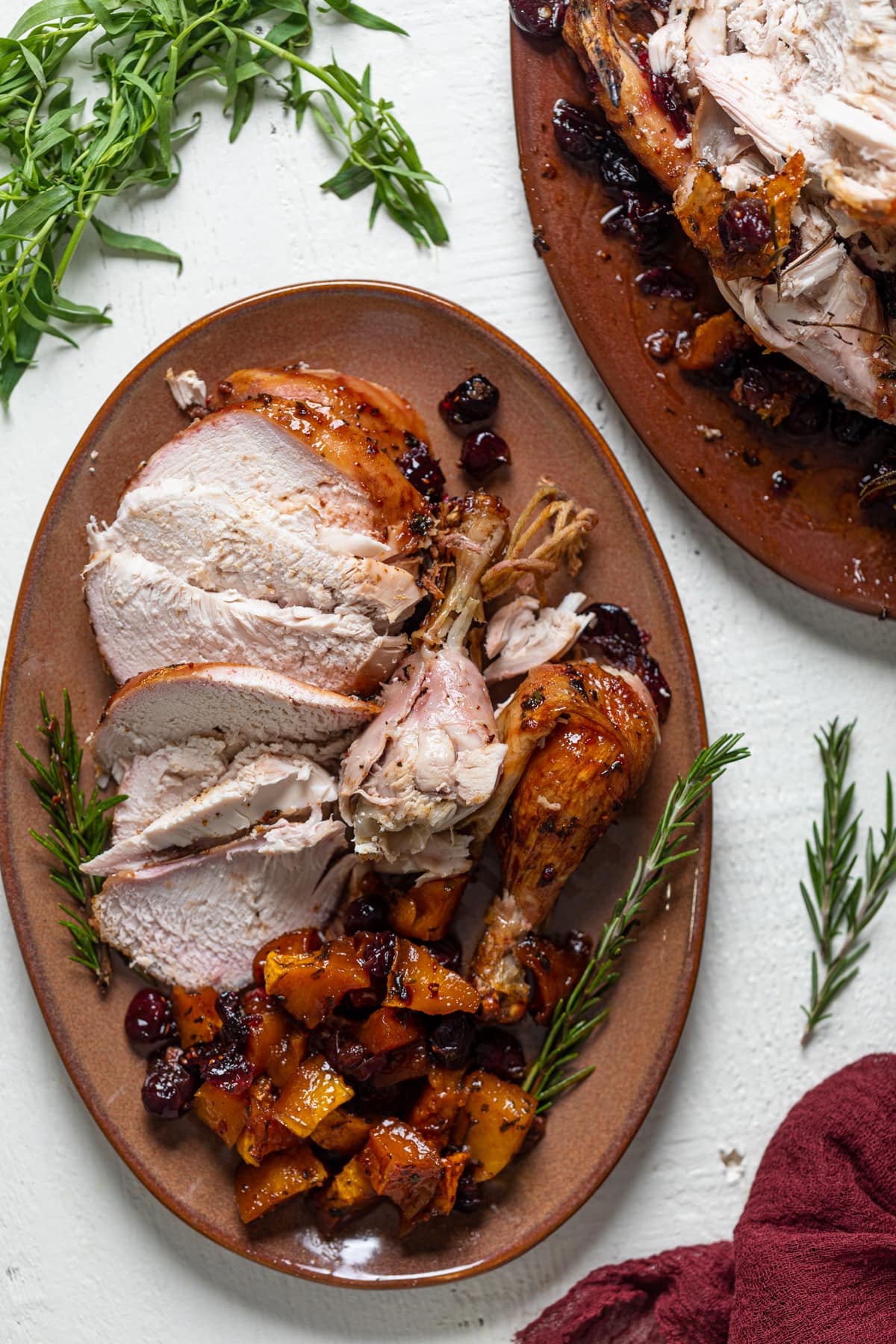 Slices and pieces of Cranberry Maple Roast Chicken on a serving platter