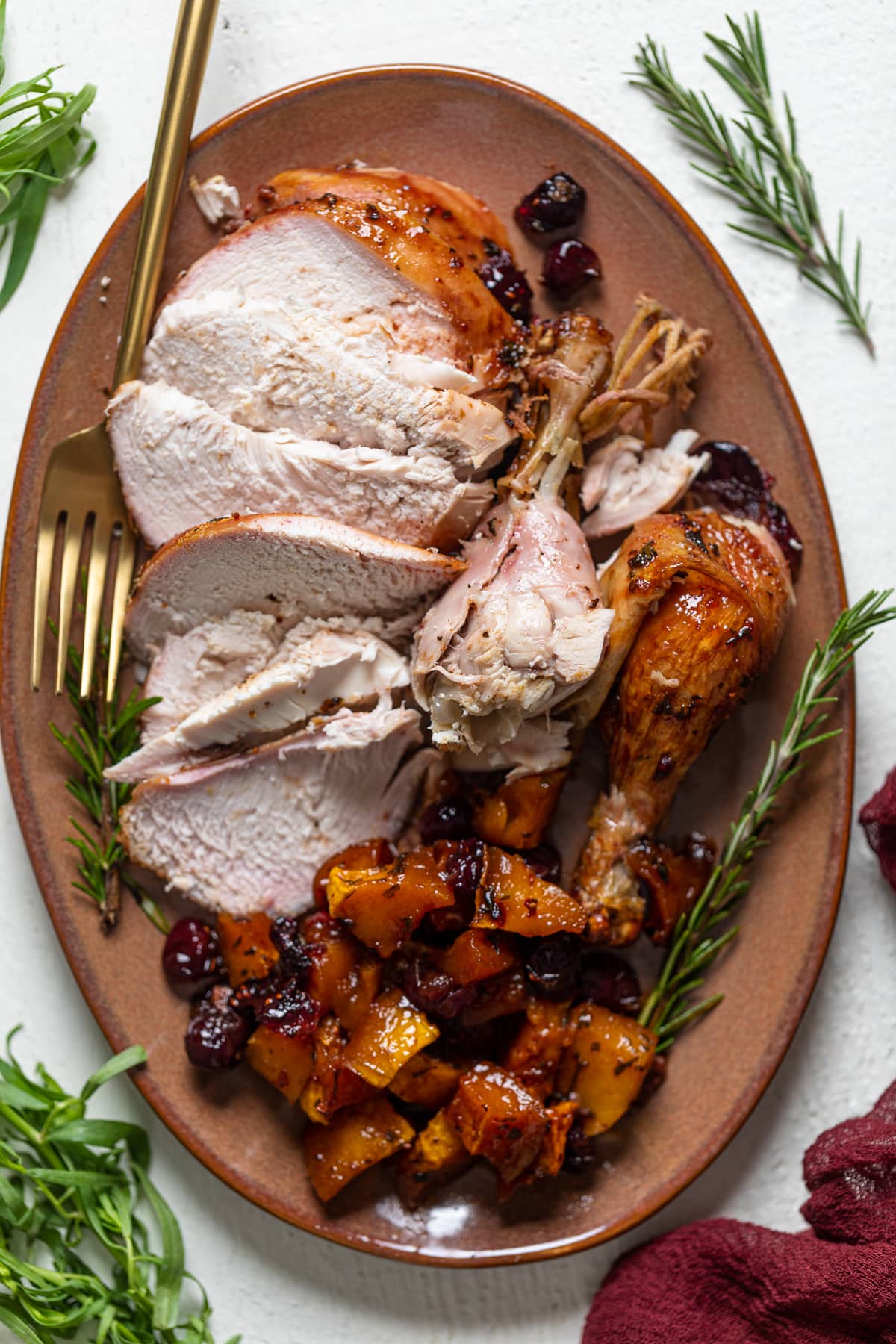 Sliced Cranberry Maple Roast Chicken on a serving platter