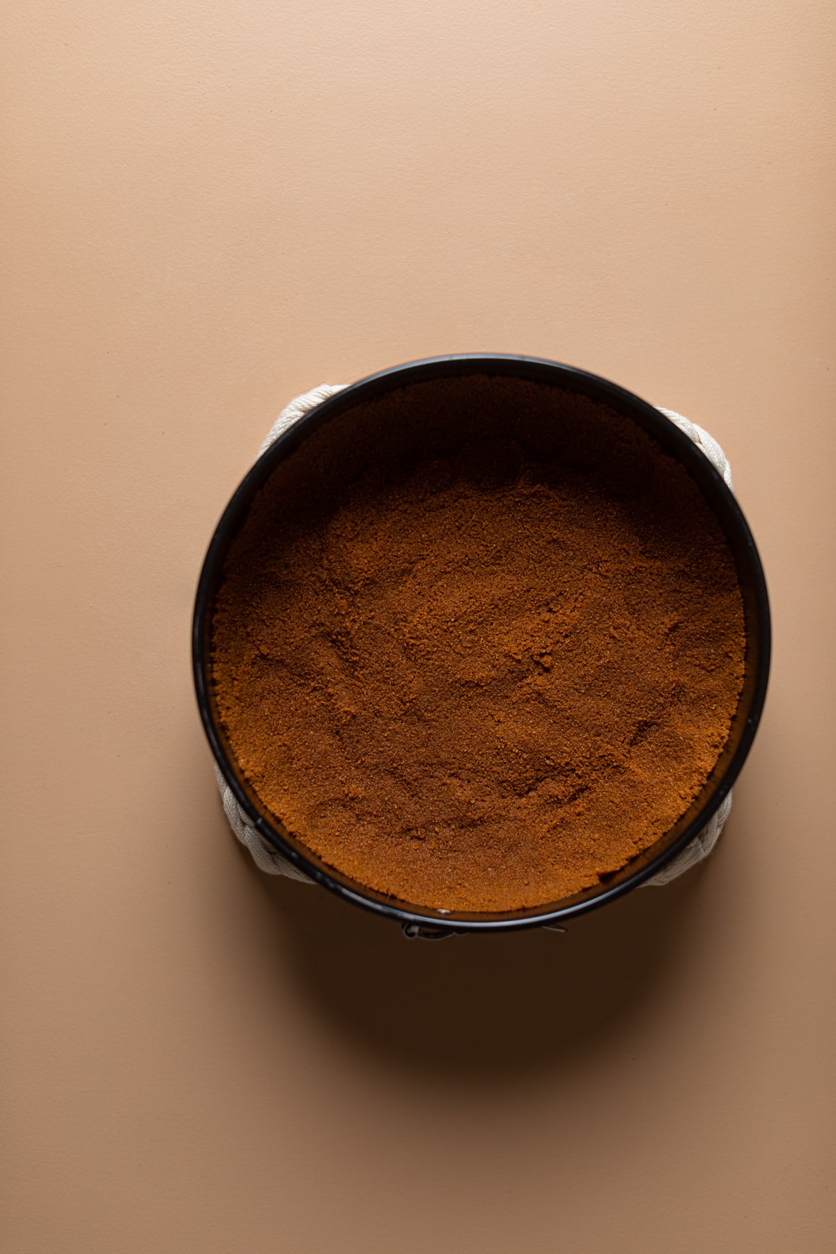 Dark brown crust pressed into a pan ready to become the best holiday dessert