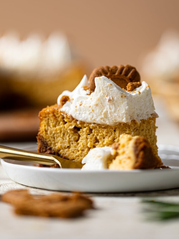 Fork and a slice of Pumpkin Cheesecake topped with a Biscoff Cookie