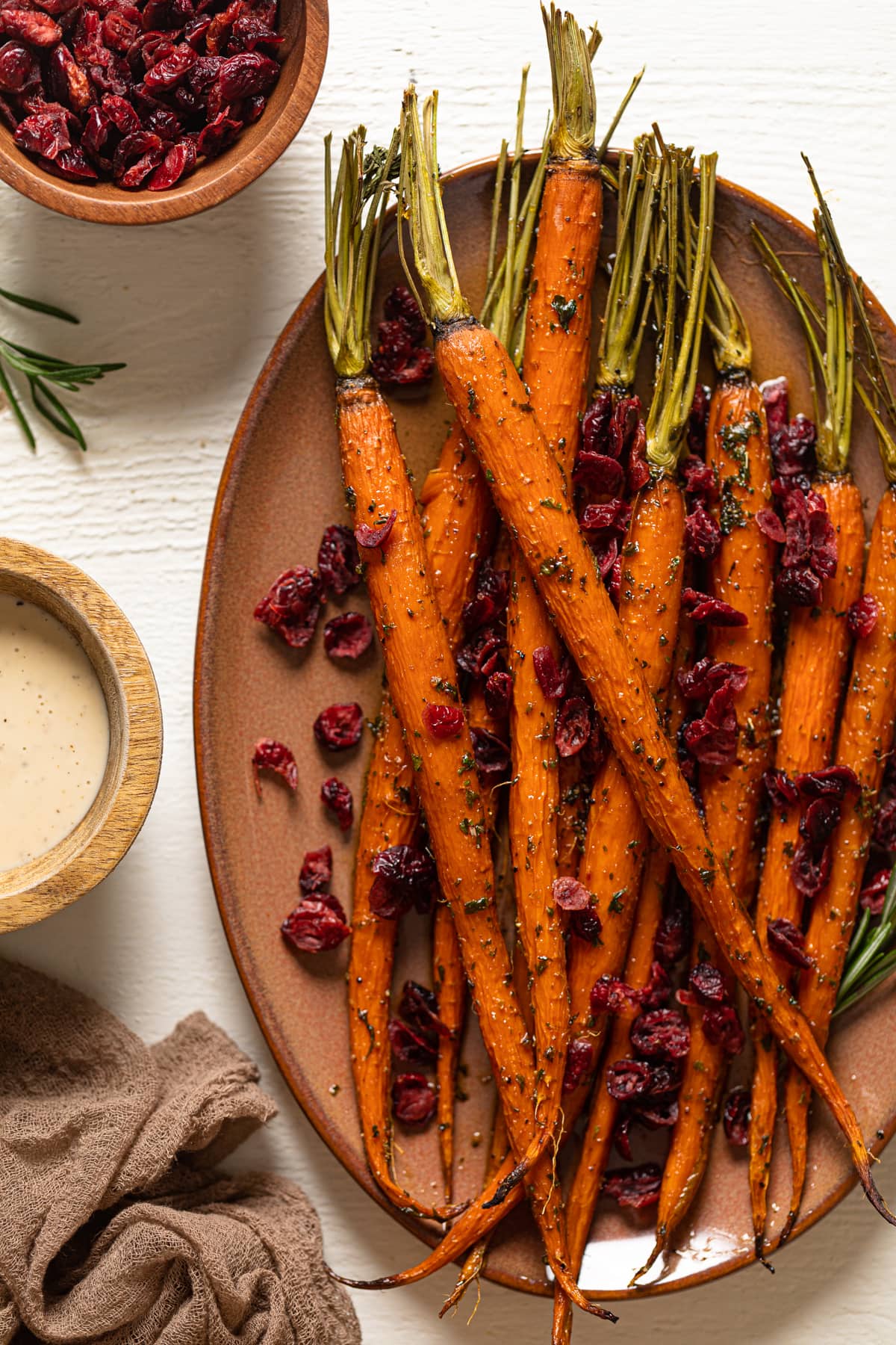 Maple Herb and Cranberries on a light brown serving platter set on a white table