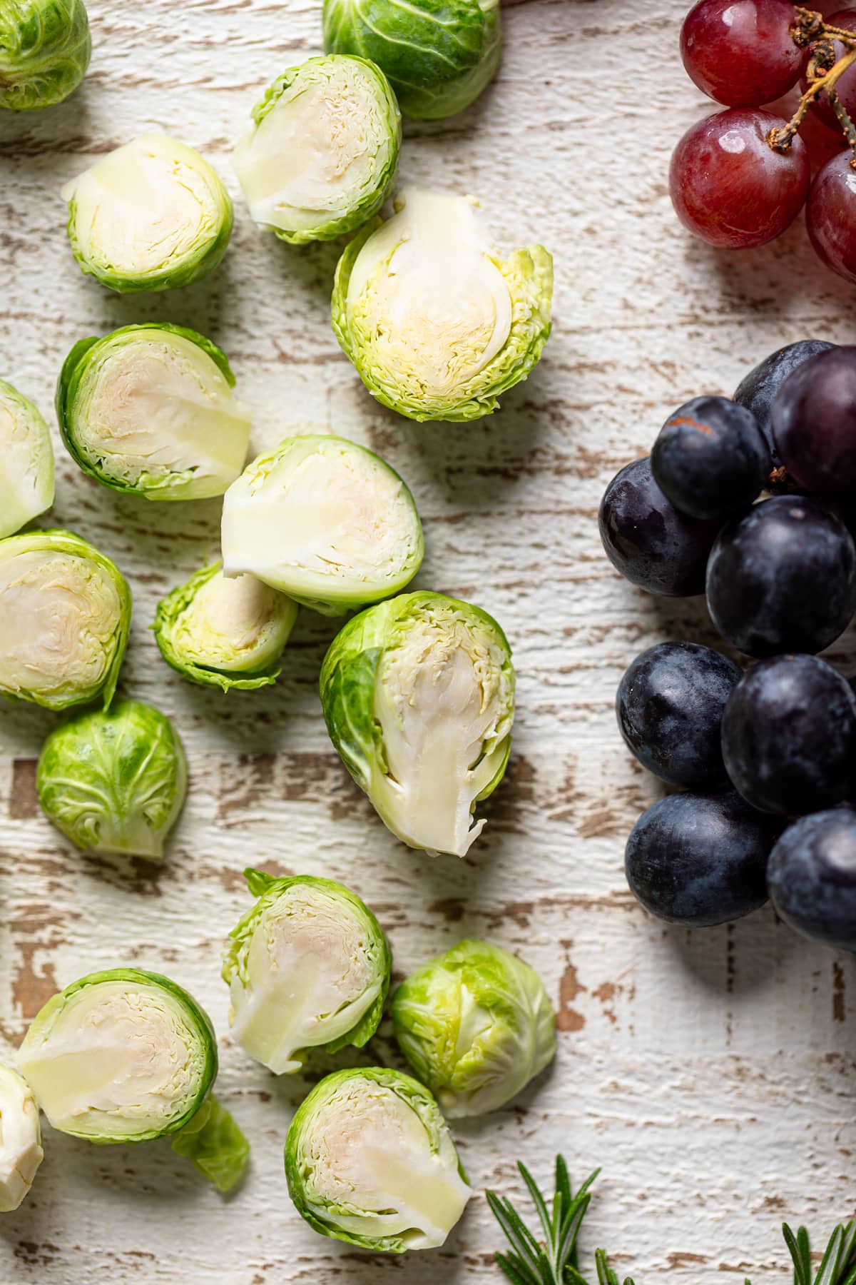 Grapes and halved brussels sprouts on a white table