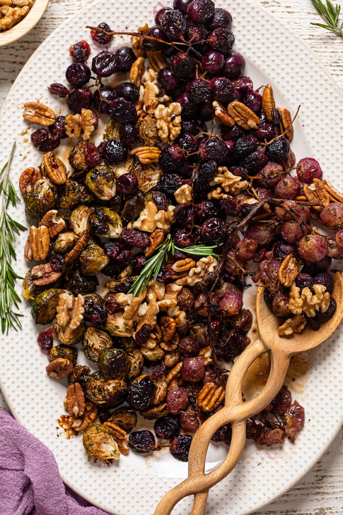 Wooden spoon scooping Roasted Grapes and Brussels Sprouts