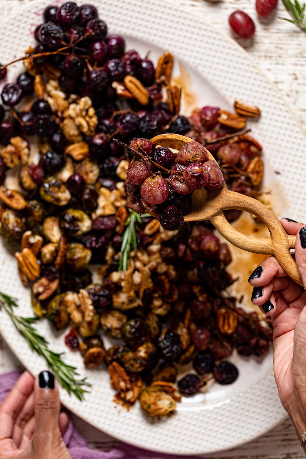 Wooden spoon full of roasted grapes