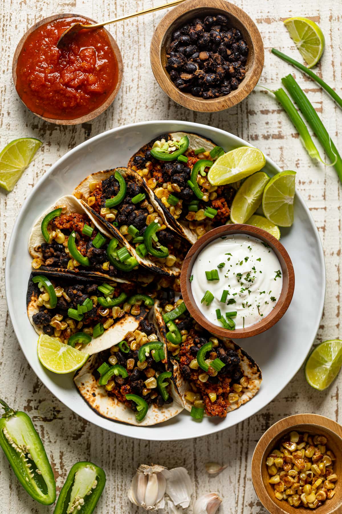 Overhead shot of a plate of Spicy Sofritas Quinoa Tacos with lime sour cream