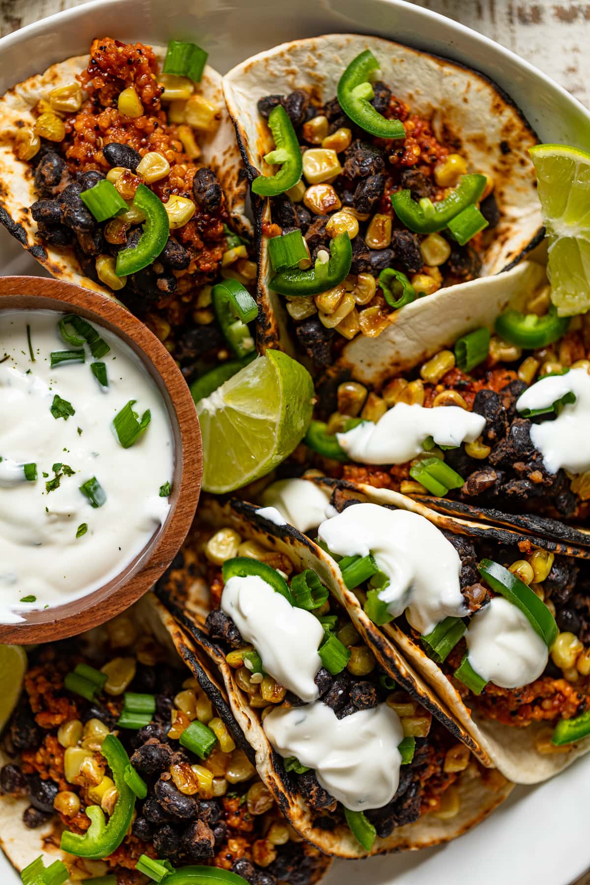 Closeup of Spicy Sofritas Quinoa Tacos with lime sour cream