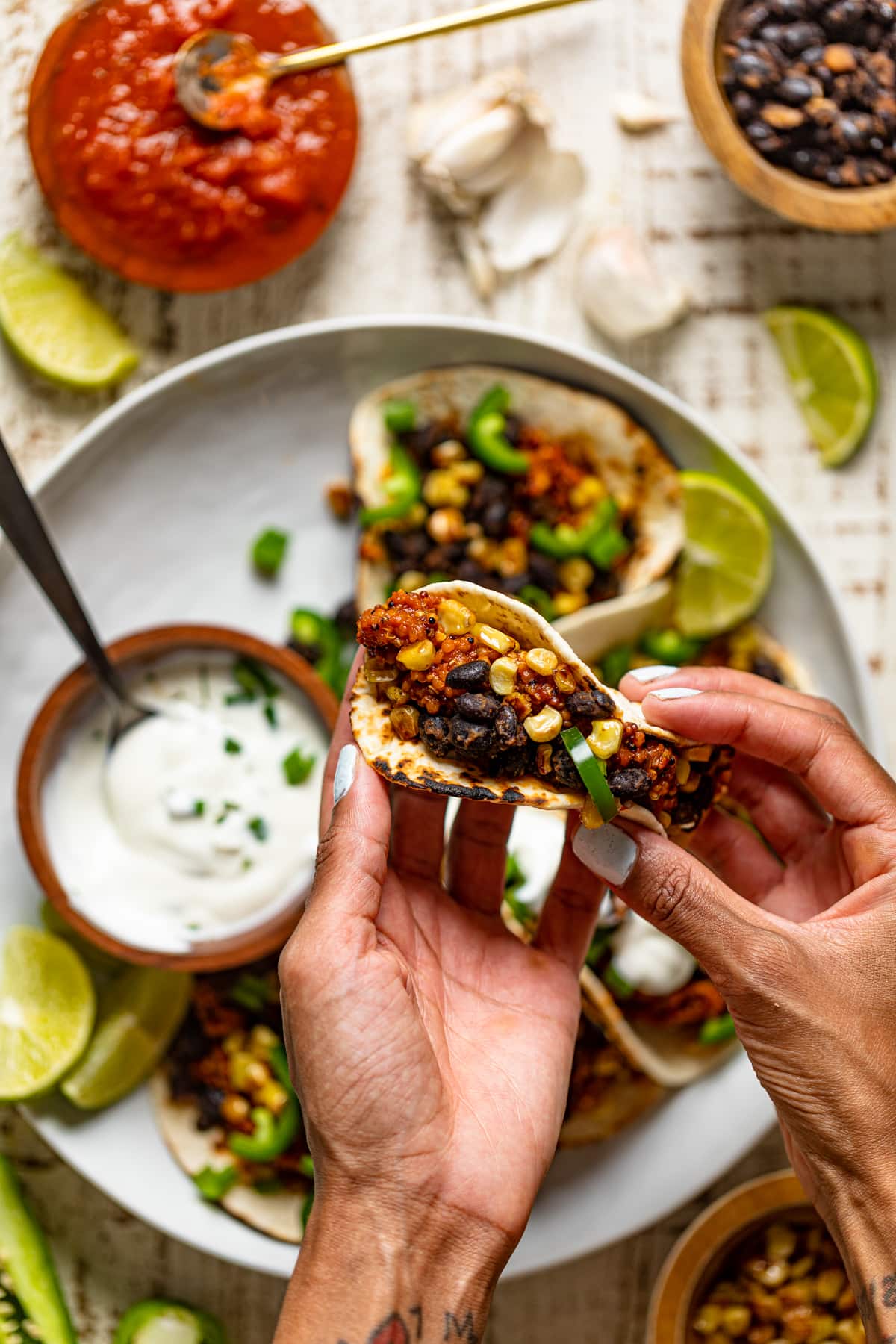 Hand holding a Spicy Sofritas Quinoa Taco