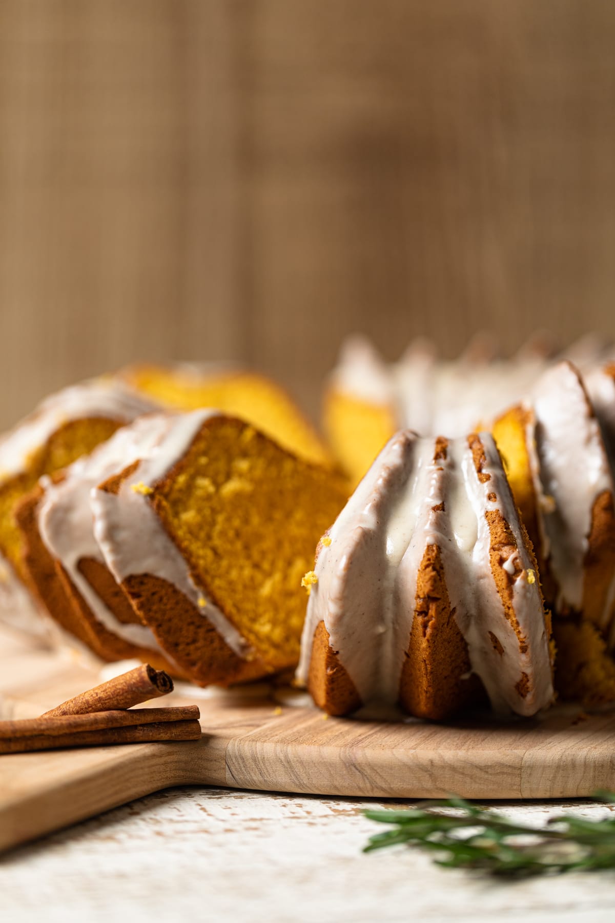 Slices of Sweet Potato Bundt Cake with Maple Glaze on a wooden board