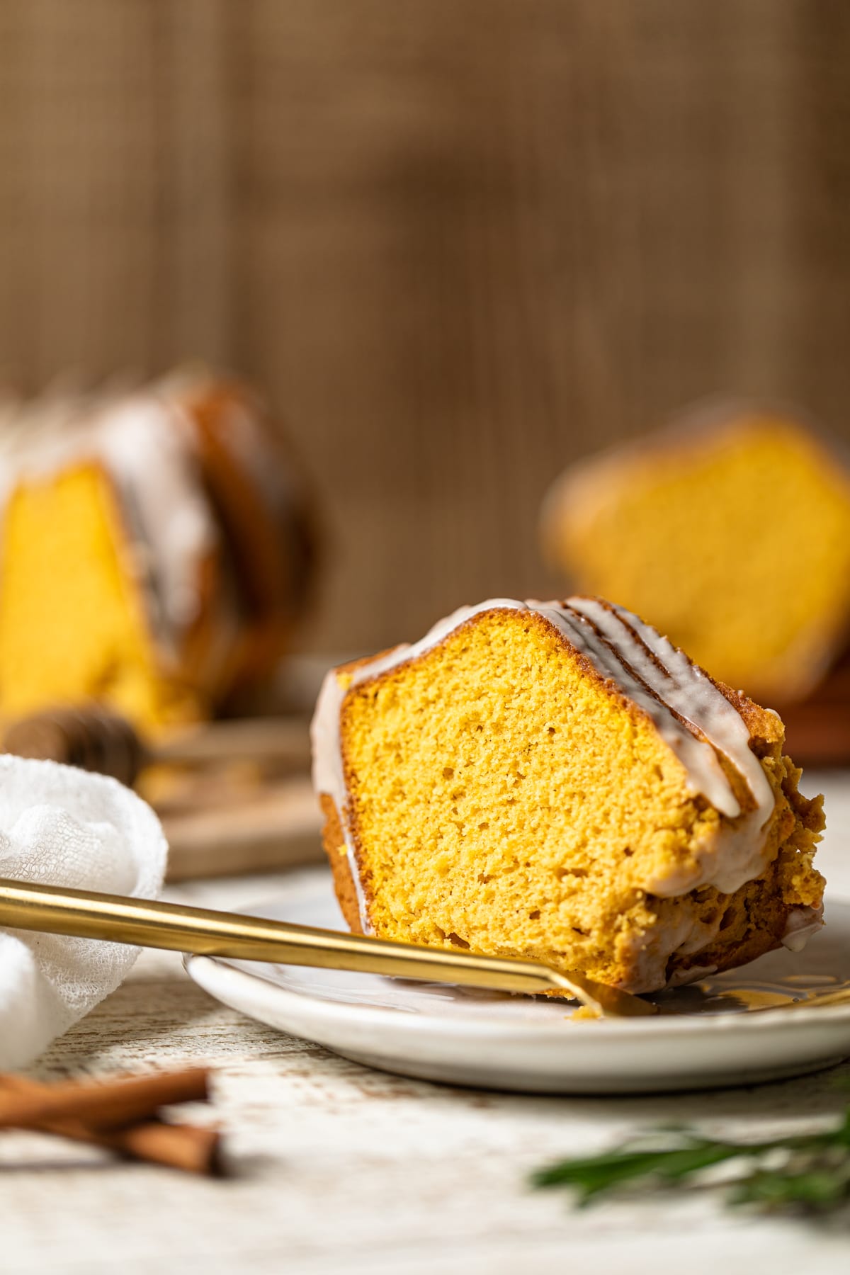 Slice of Sweet Potato Bundt Cake with Maple Glaze on a small plate with a fork