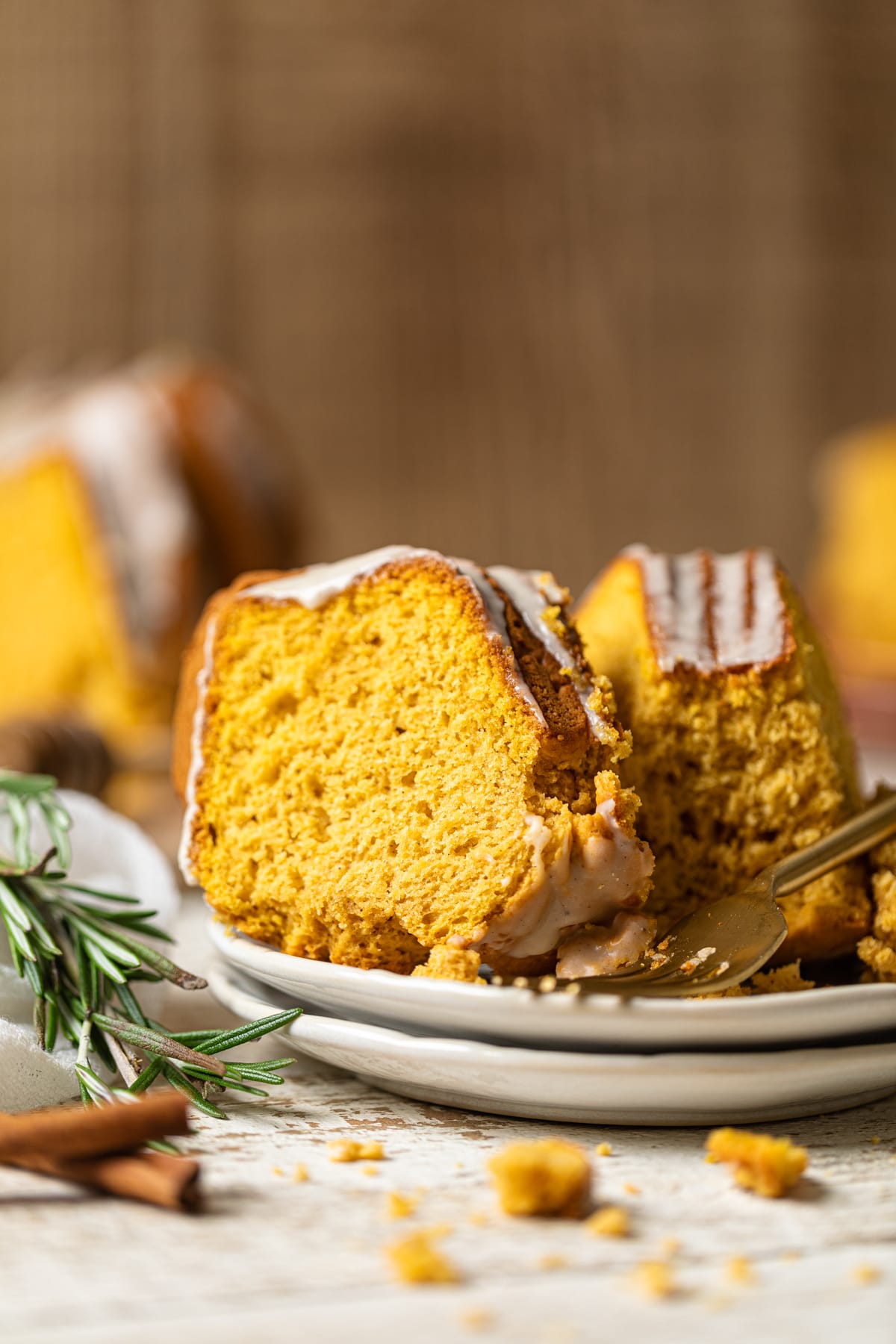 Slices of Sweet Potato Bundt Cake with Maple Glaze on two small, stacked plates