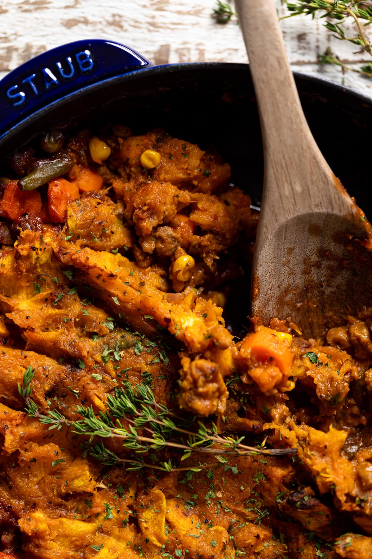 Closeup of a wooden spoon scooping Butternut Squash Sweet Potato Shepherd’s Pie 