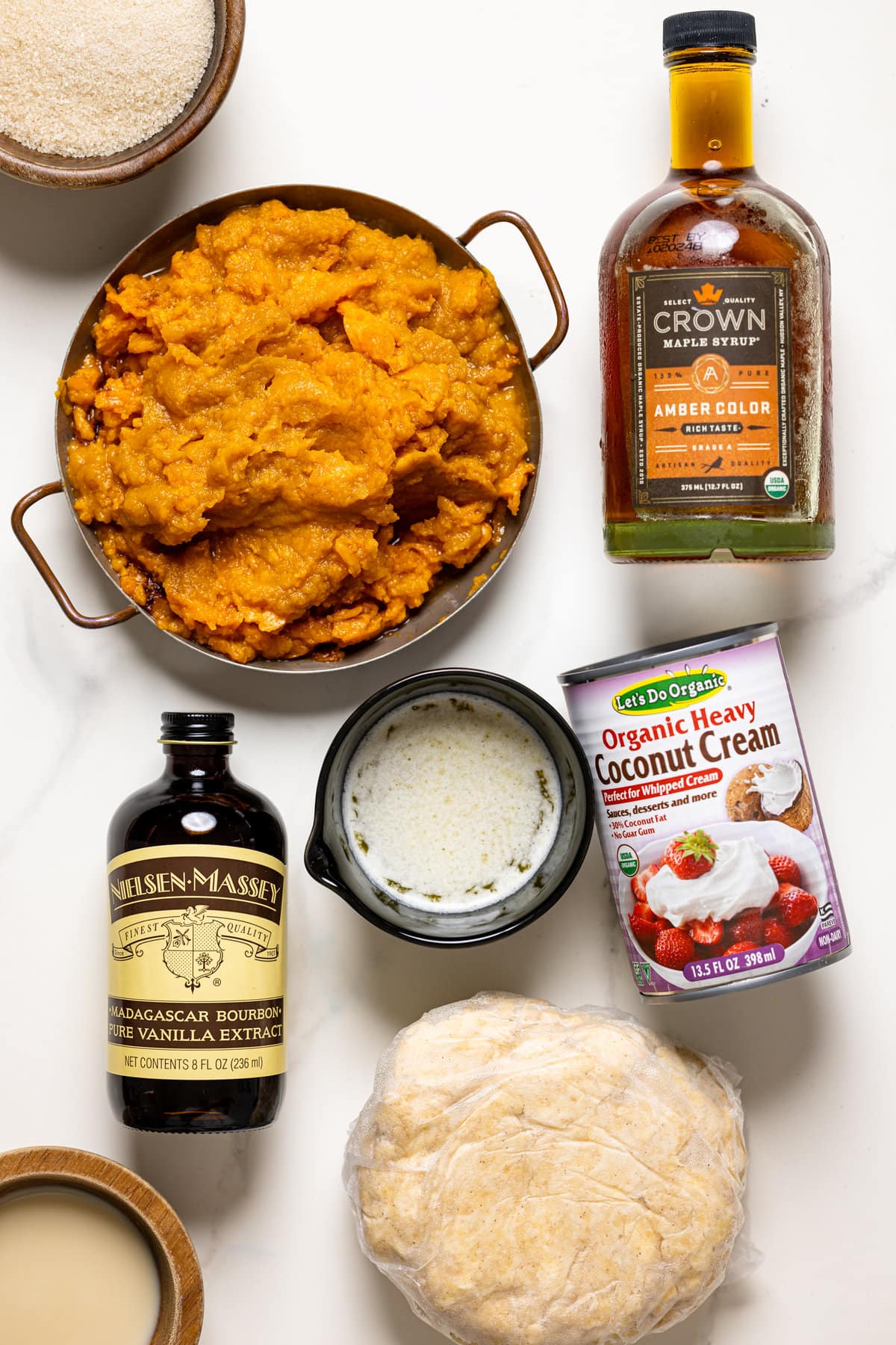 Ingredients for Vegan Sweet Potato Pie including coconut cream, maple syrup, and vanilla extract