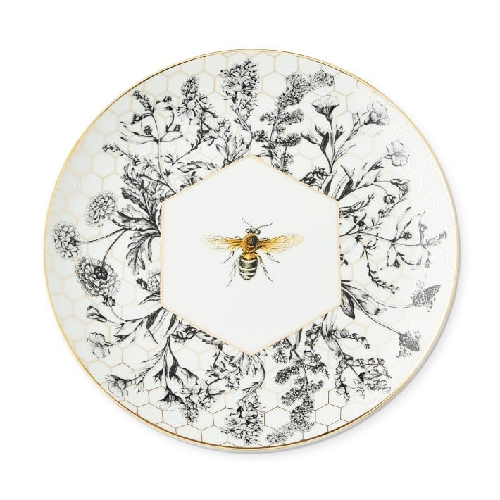 Small plate decorated with black and white flowers and a yellow bee