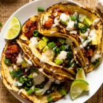 Chipotle BBQ Butternut Squash Tacos drizzled with dairy-free garlic lime sauce