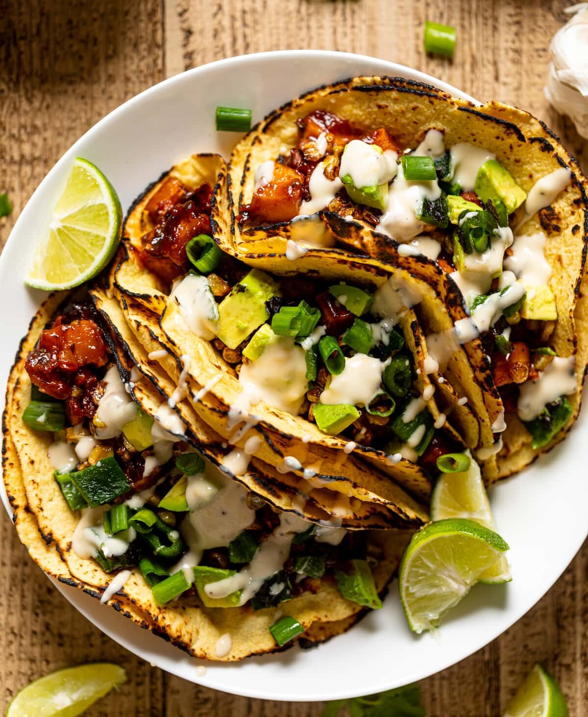 Chipotle BBQ Butternut Squash Tacos drizzled with dairy-free garlic lime sauce