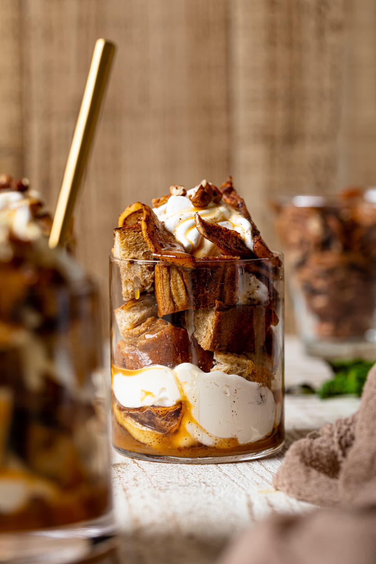 Caramel Apple French Toast Parfait in a glass on a white table