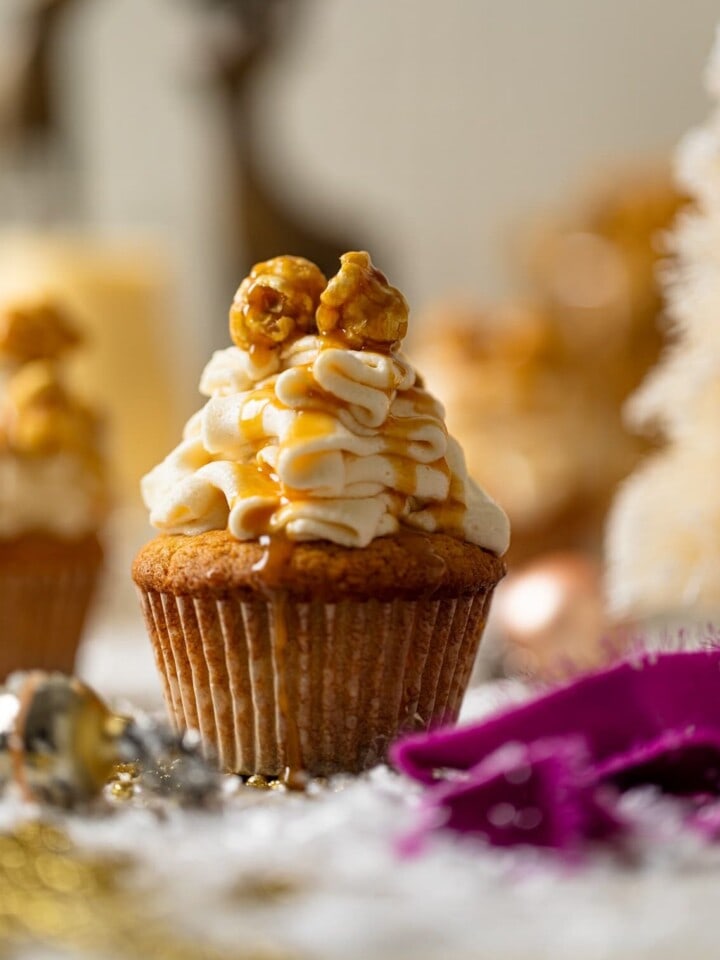 Caramel Eggnog Cupcake on a table with Christmas decorations
