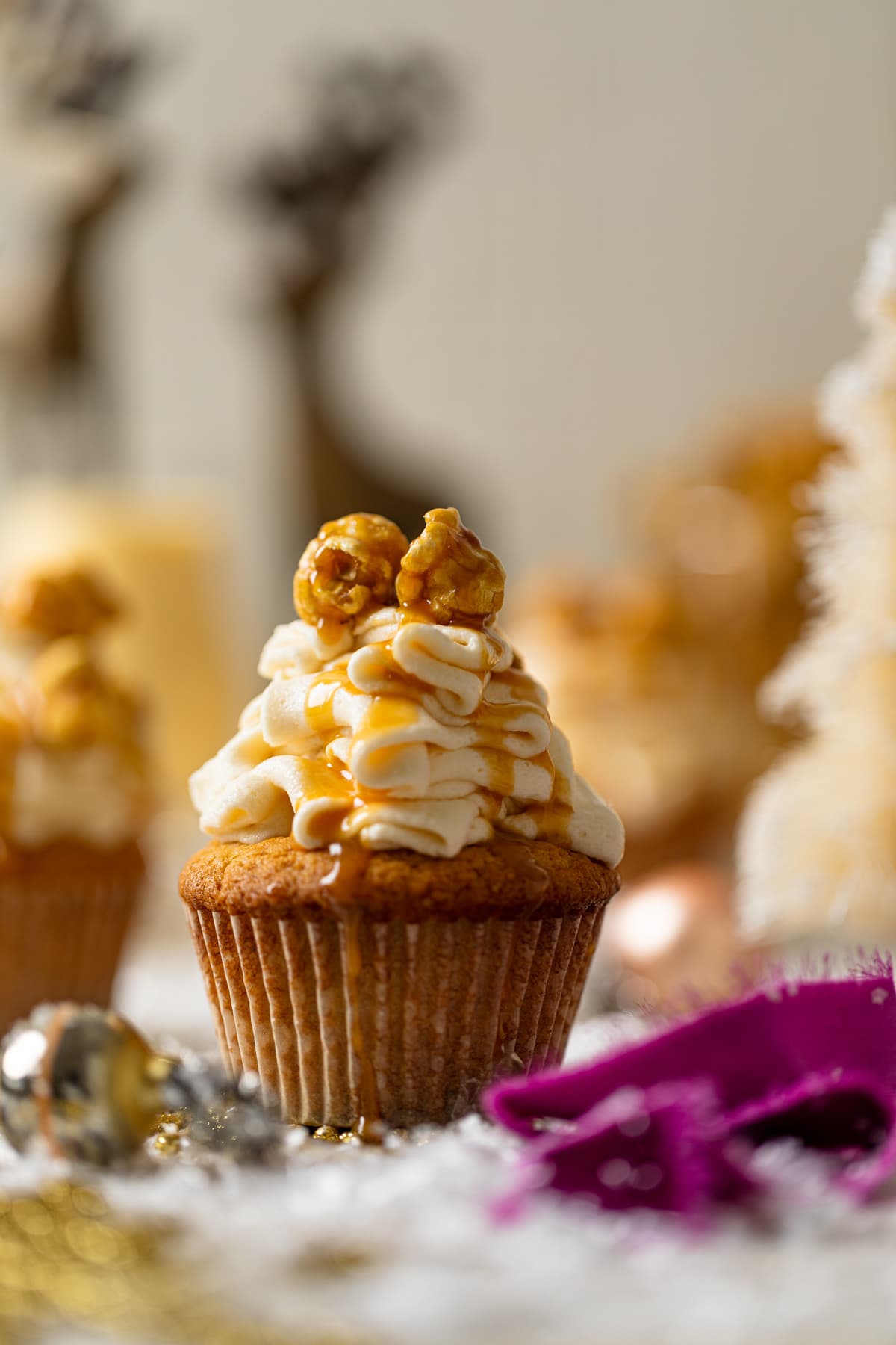 Caramel Eggnog Cupcake topped with caramel popcorn and caramel drizzle