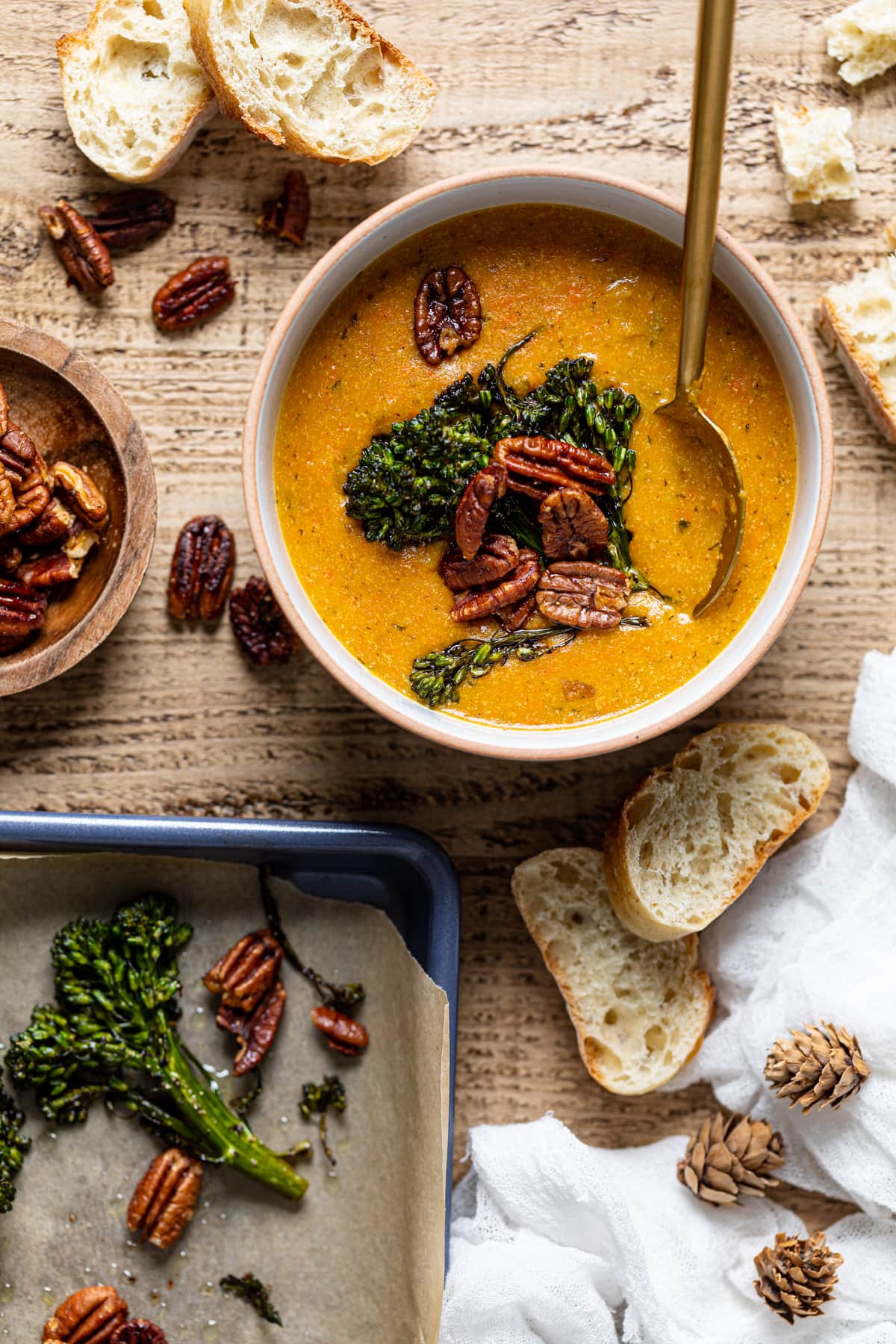 Overhead shot of a bowl of plant-based Cheddar Carrot Apple Soup with a spoon