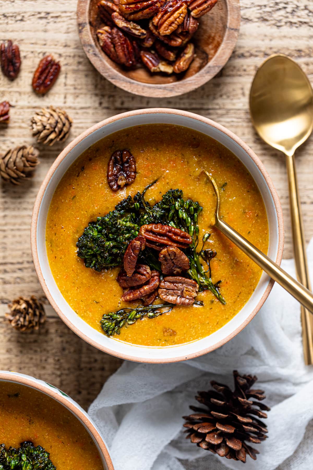 Spoon in a bowl of plant-based Cheddar Carrot Apple Soup