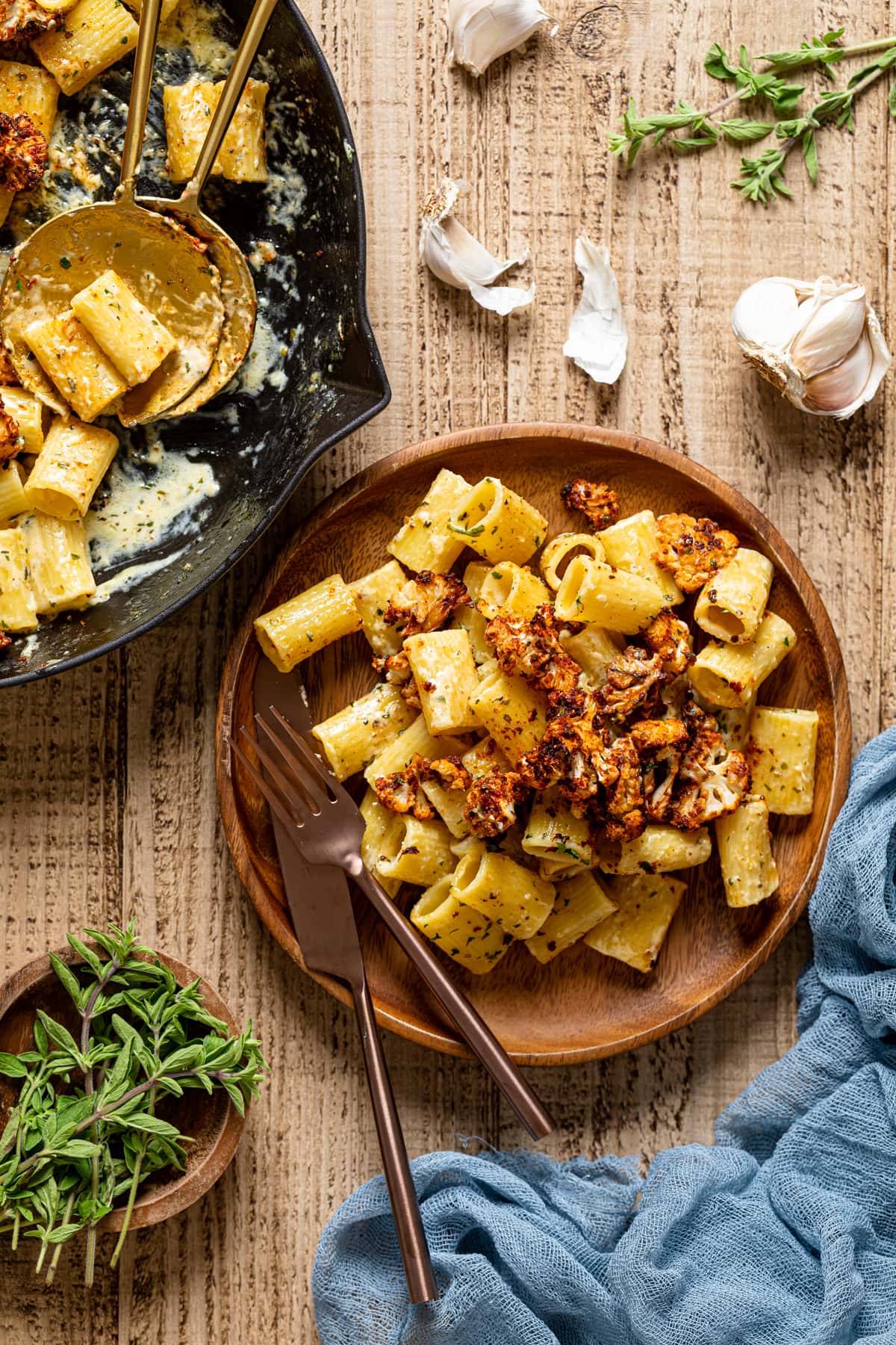 Creamy Garlic Butter Pasta with Roasted cauliflower on a wooden plate