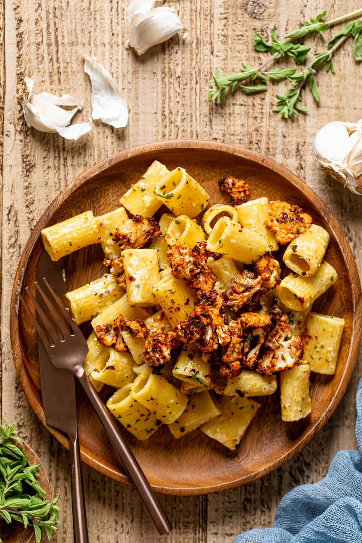 Creamy Garlic Butter Pasta with Roasted cauliflower on a wooden plate