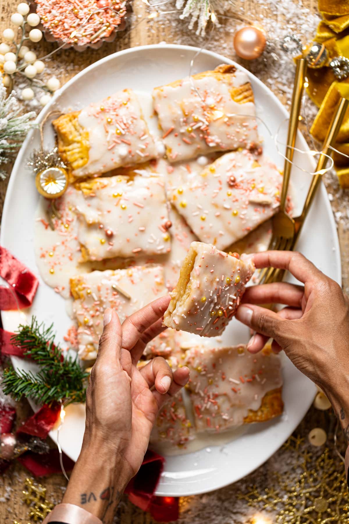 Hands holding a slice of Giant Orange Marmalade Pop Tart