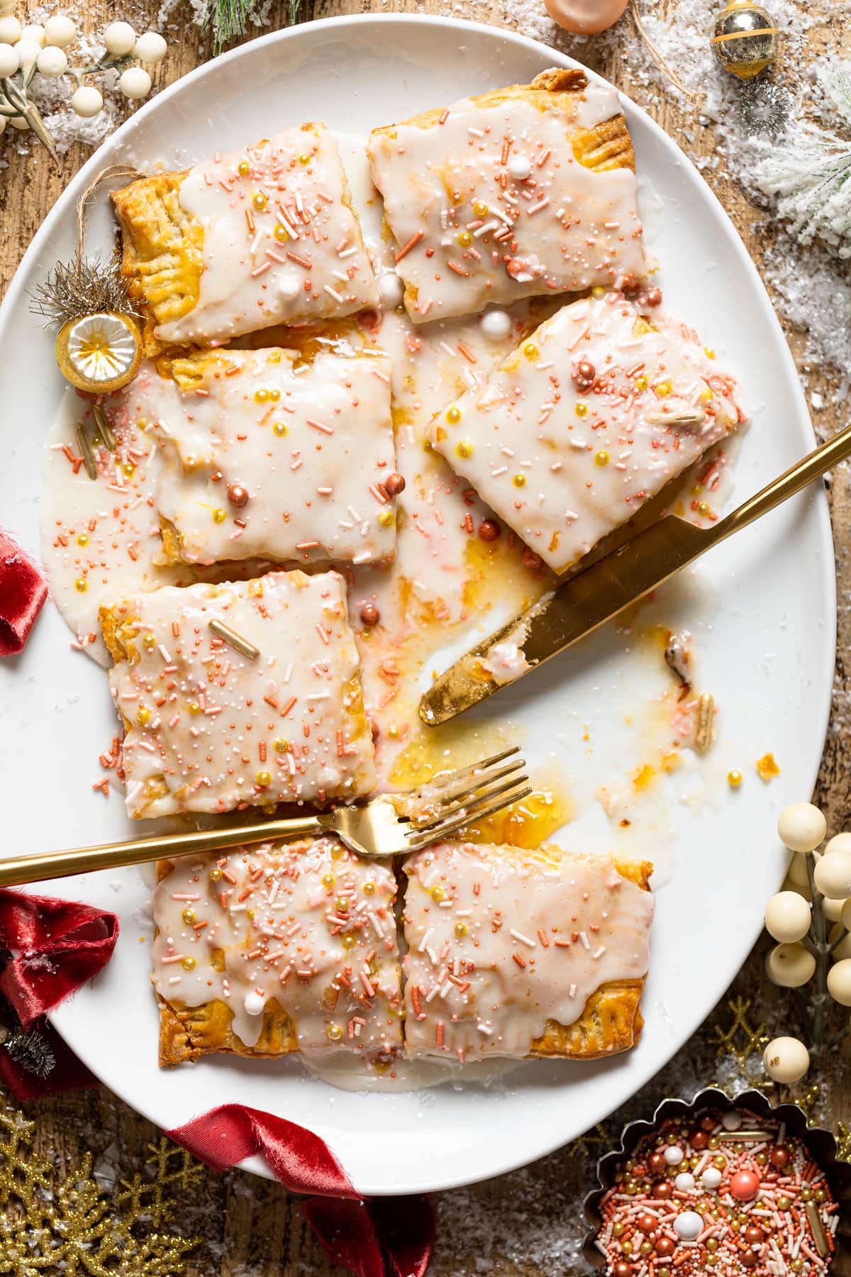 Overhead shot of a sliced Giant Orange Marmalade Pop Tart on a serving platter with a fork and knife