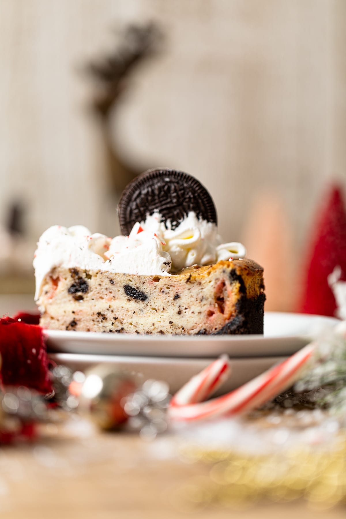 Slice of Peppermint Oreo Cheesecake topped with an Oreo