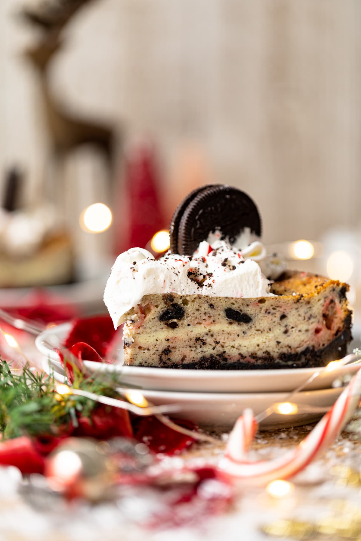 Slice of Peppermint Oreo Cheesecake topped with an Oreo