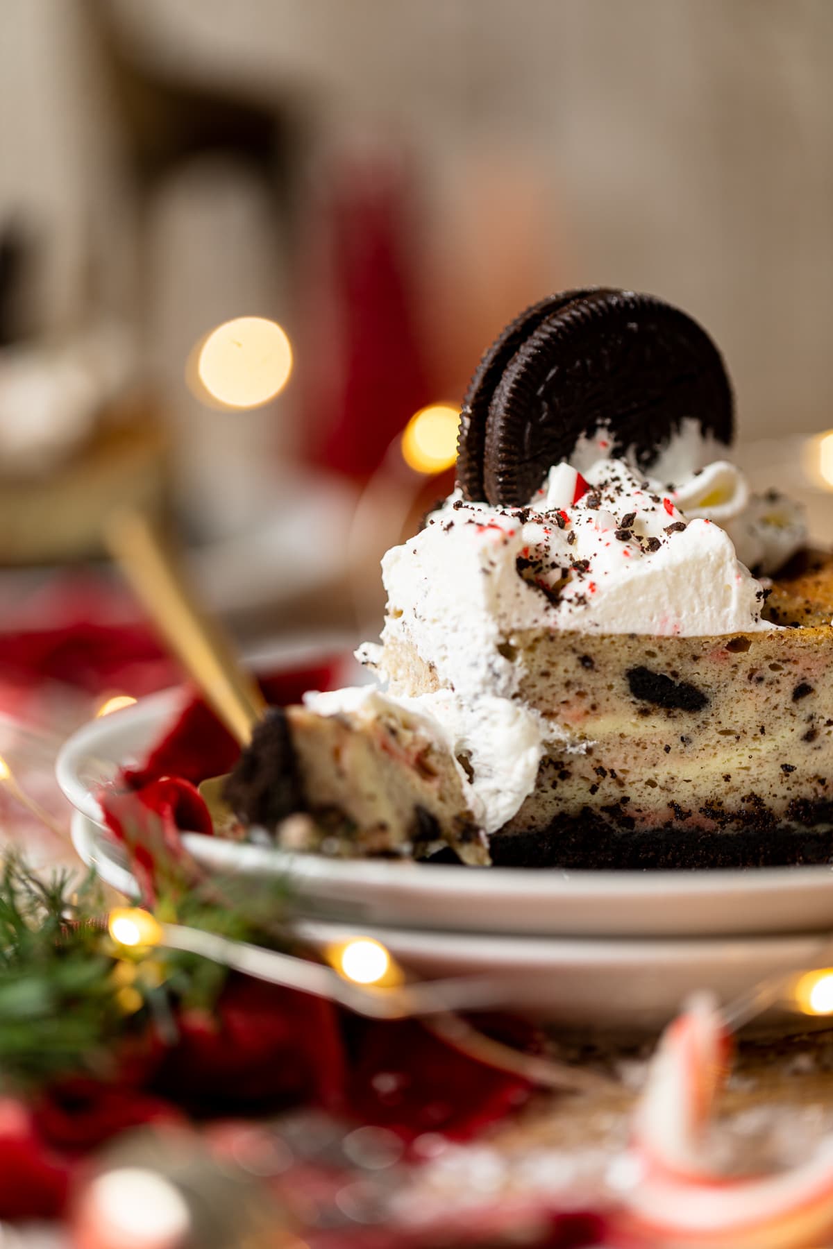 Fork taking a piece off of a slice of Peppermint Oreo Cheesecake